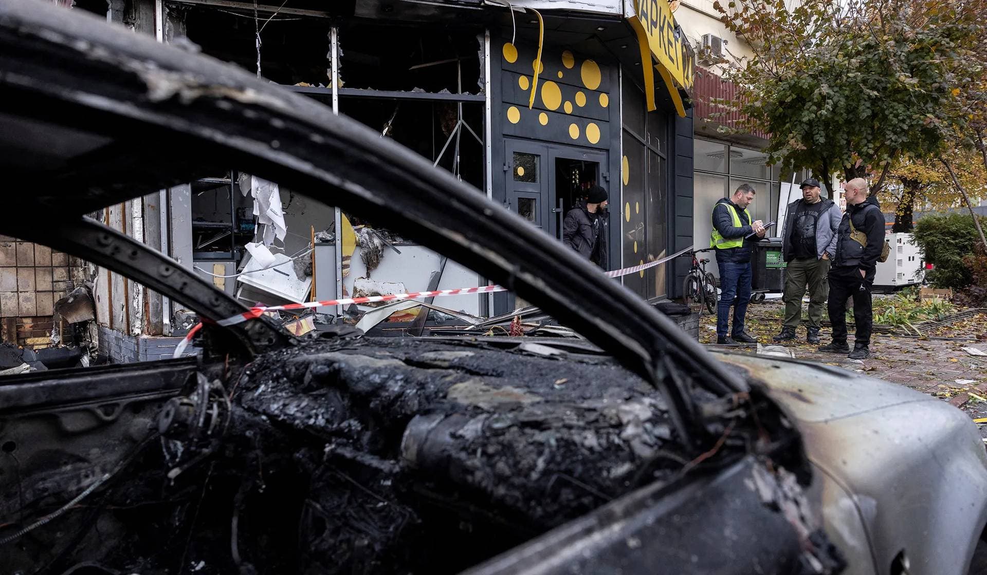 Investigators work at the site of a Russian drone strike in Kyiv