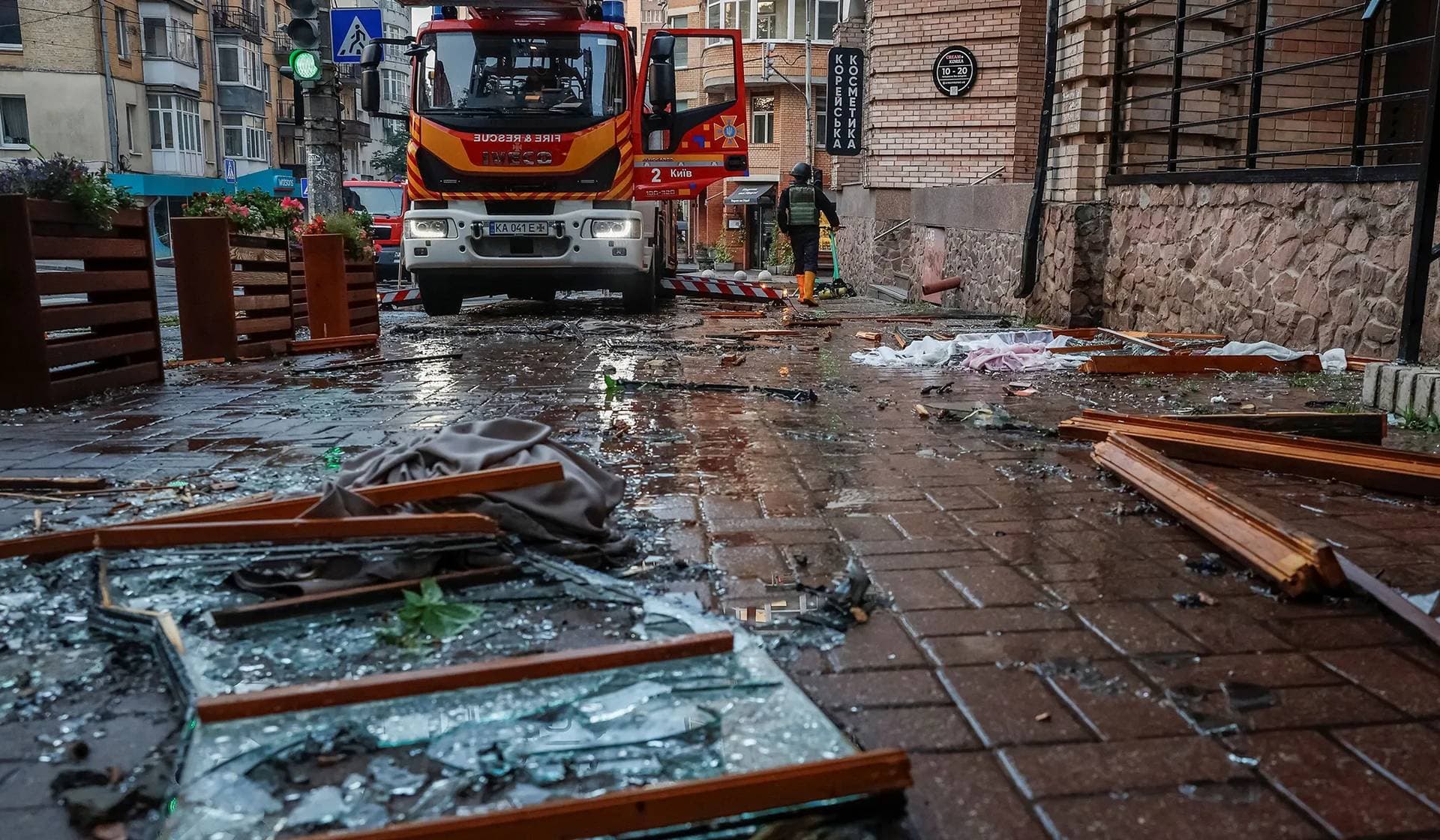A firefighter works at a site of an apartment building that was damaged during Russian drone and missile strikes in Kyiv
