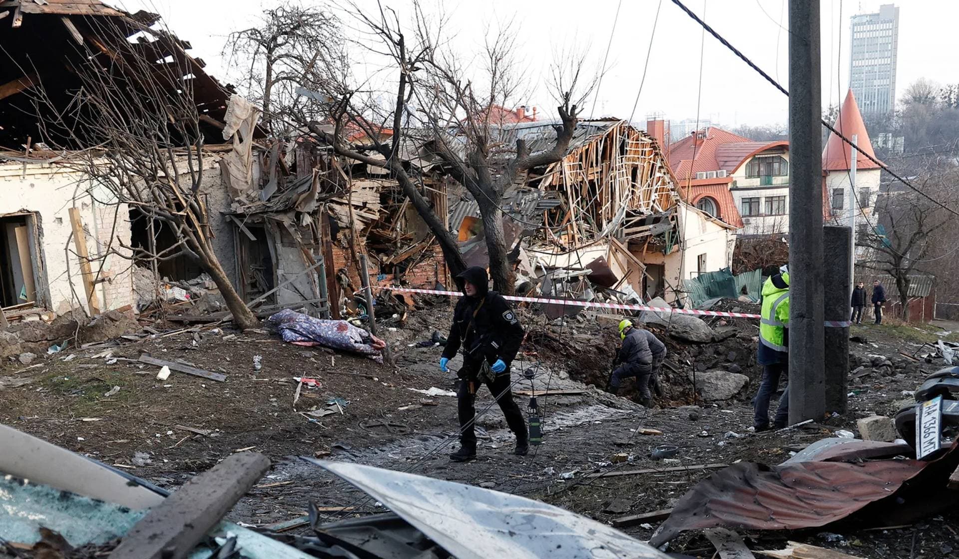 Police officers walk at a site of a Russian missile strike in Kyiv