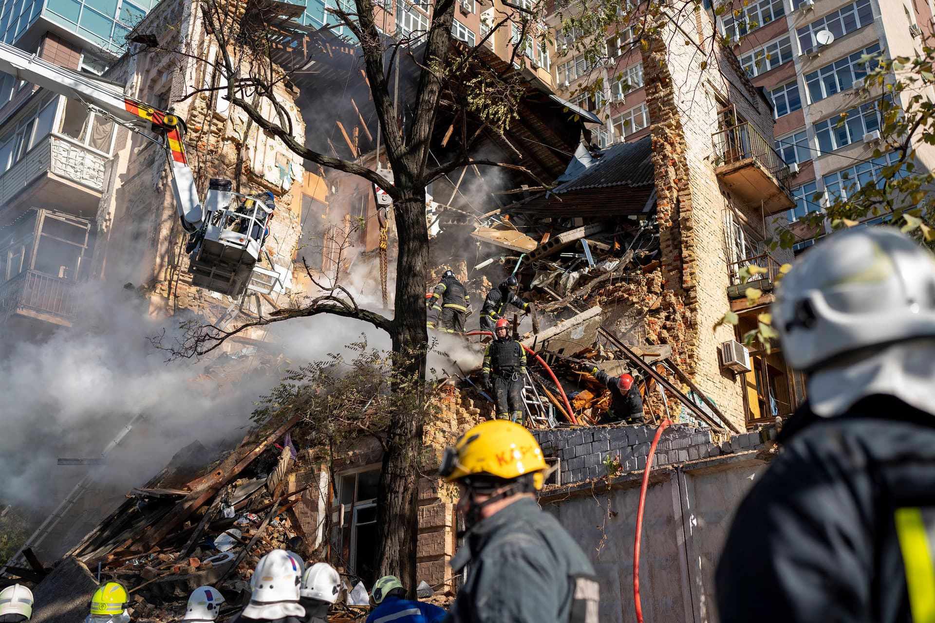 Firefighters work after a drone fired on buildings in Kyiv