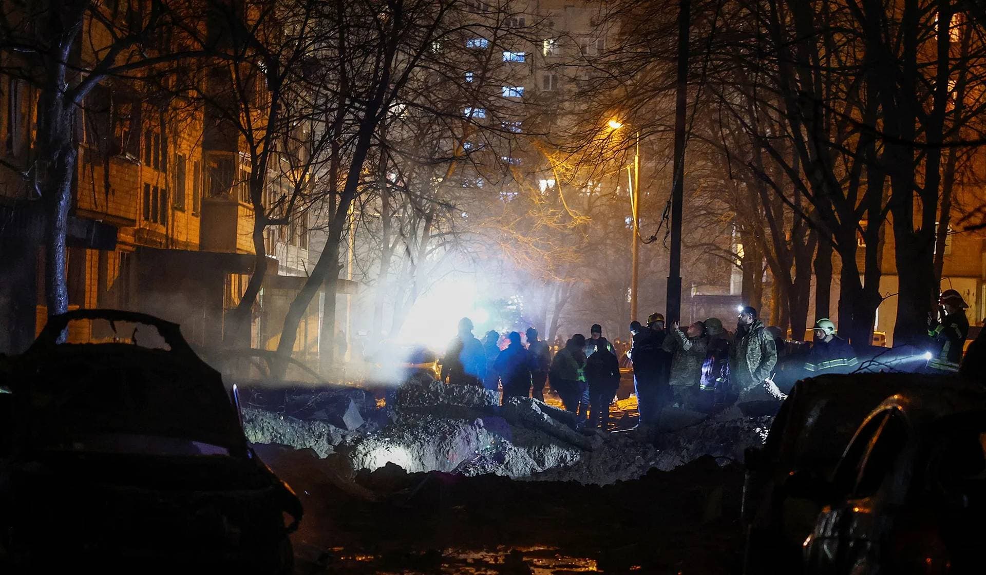 Emergency staff work at a site of an apartment building damaged during a Russian missile strike in Kyiv