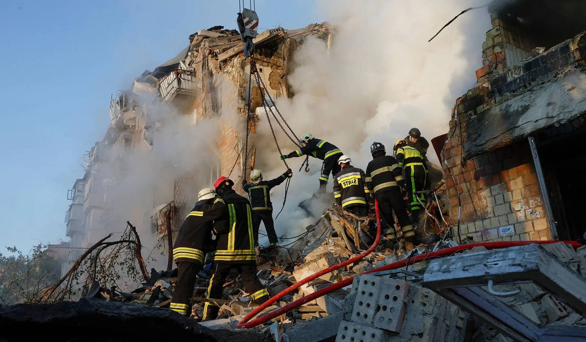 Rescuers work at the site of an apartment building hit by a Russian missile and drone strike in Kyiv