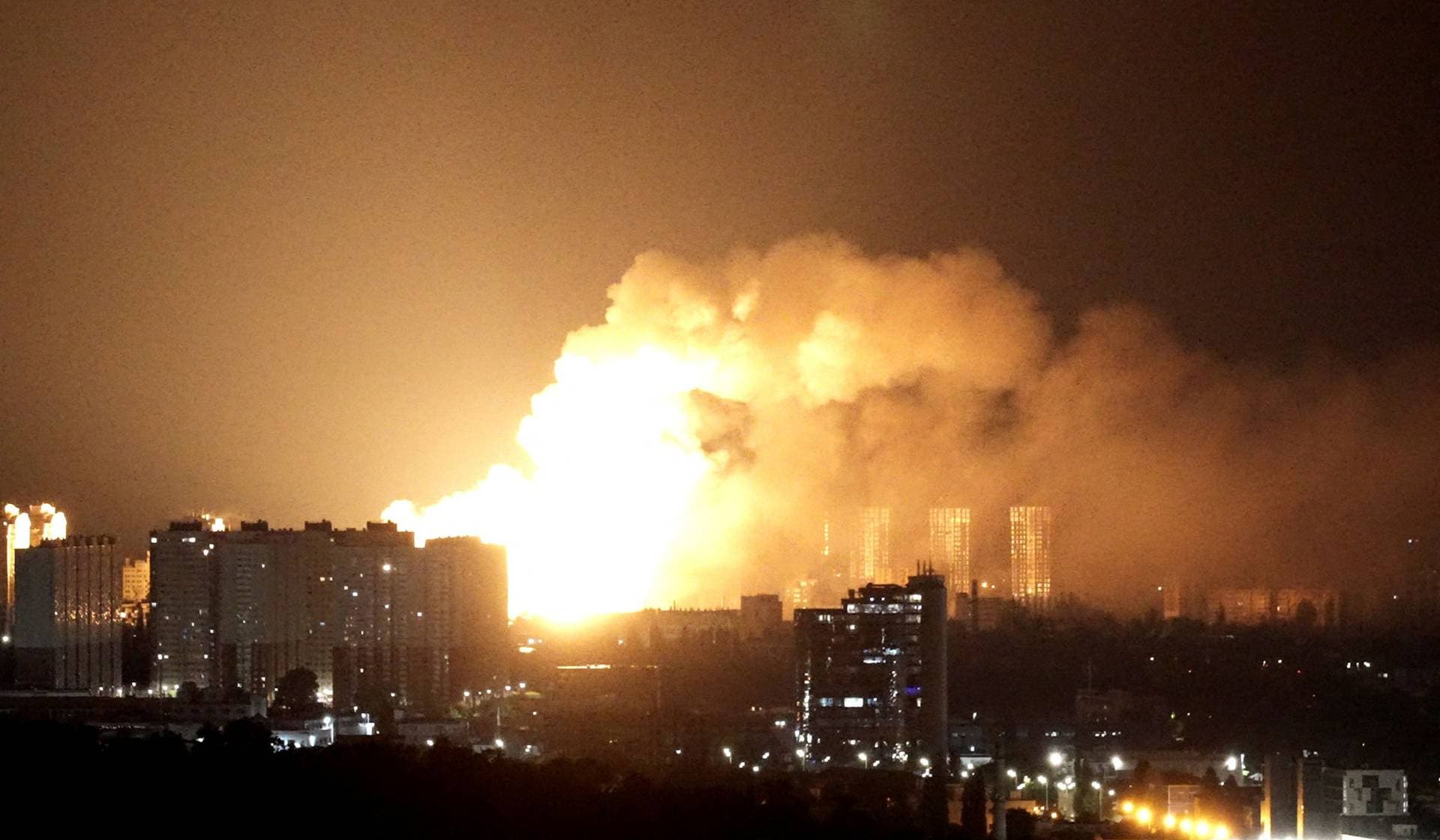 An explosion lights up the sky over the city during a Russian missile and drone strike in Kyiv