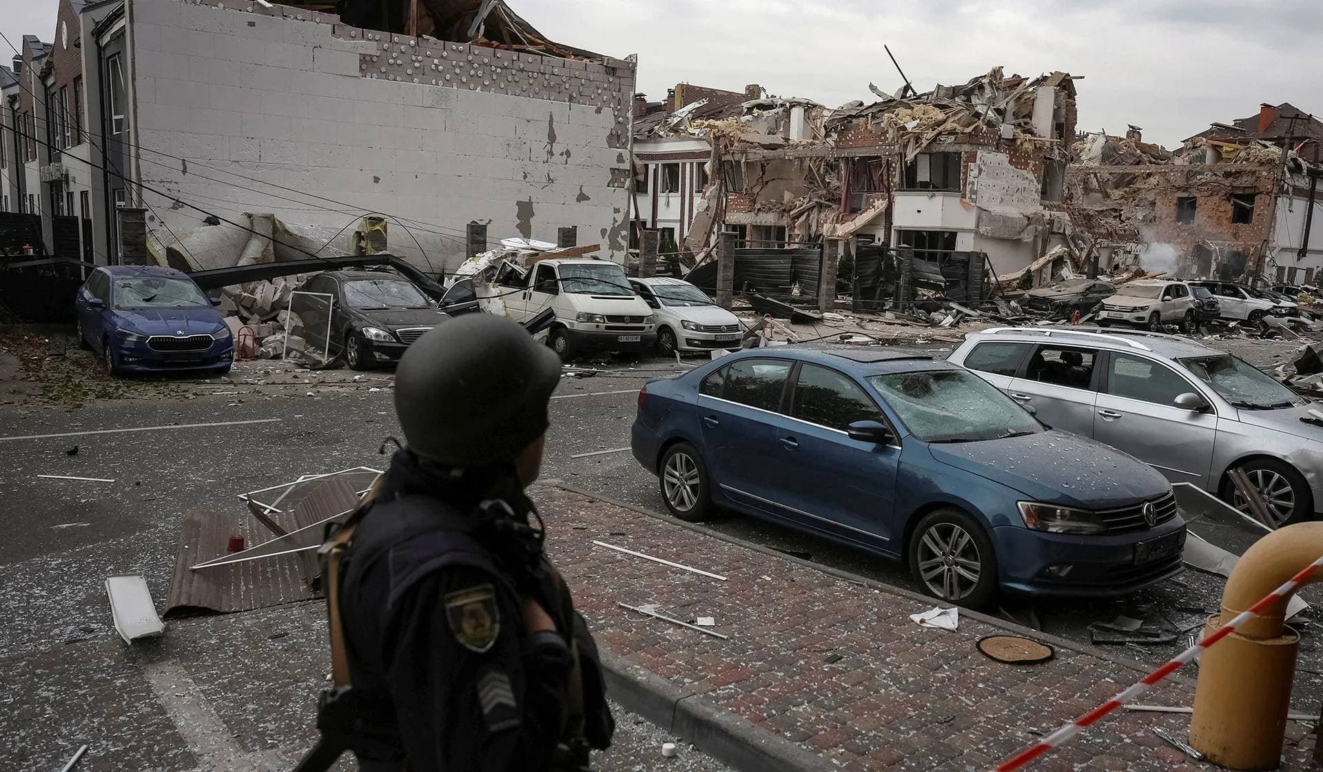 A police officer stands in residential neighbourhood hit during a Russian drone and missile strike on the outskirts of Kyiv