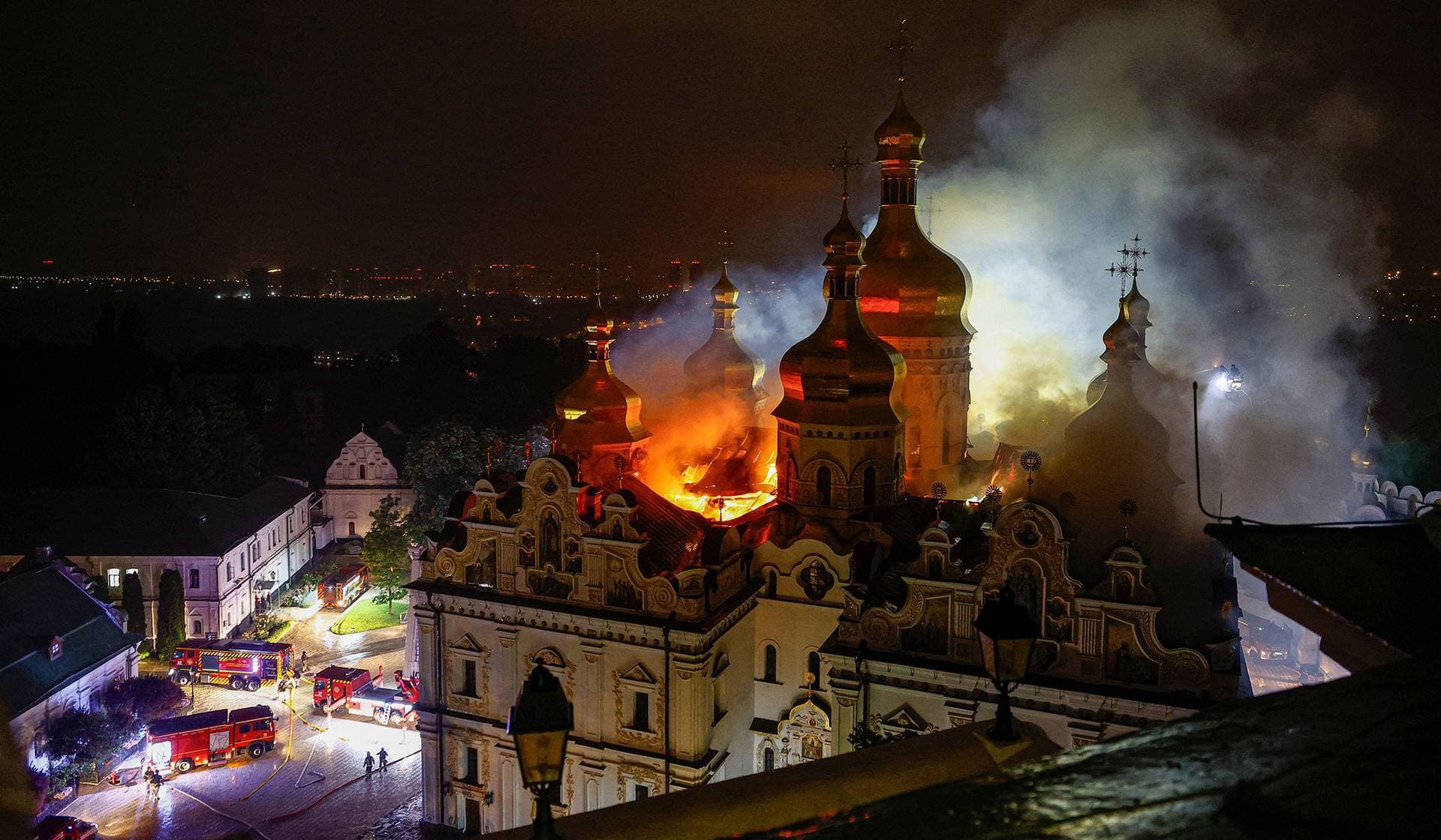 Firefighters work to extinguish a fire at the Dormition Cathedral of the Kyiv Pechersk Lavra, which was hit during Russian missile and drone strikes in Kyiv