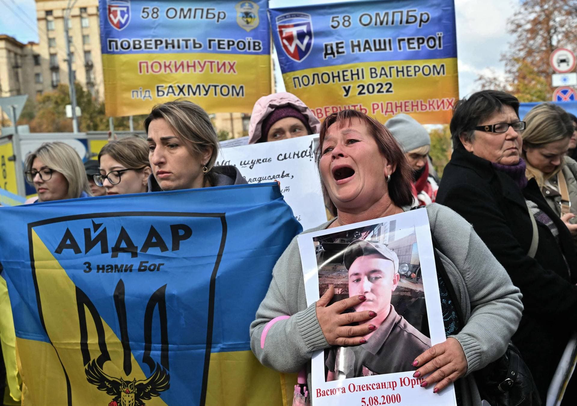 Protesters hold placards and flags depicting portraits of Ukrainian prisoners of war and missing servicemen during a rally demanding their search and liberation in Kyiv