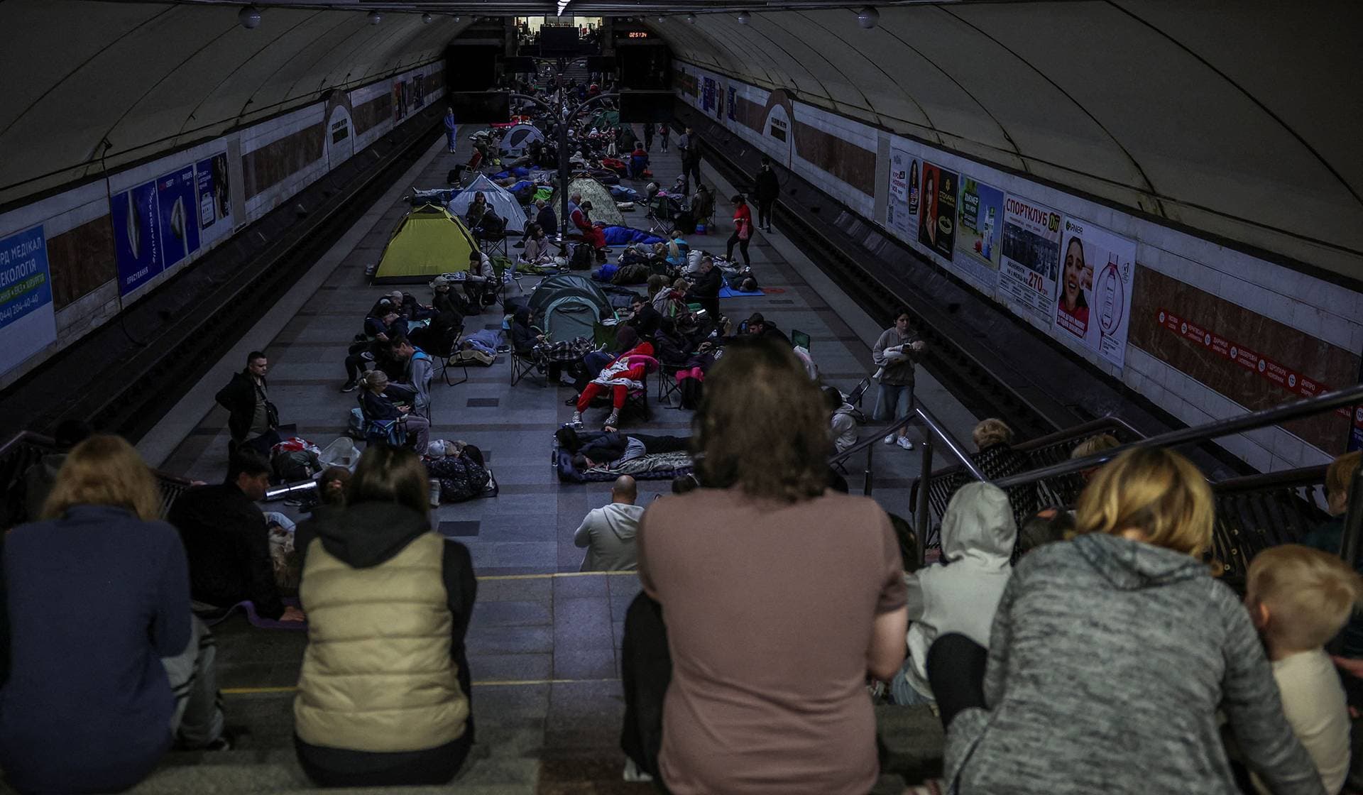 People take shelter inside a metro station during a Russian missile and drone strike in Kyiv