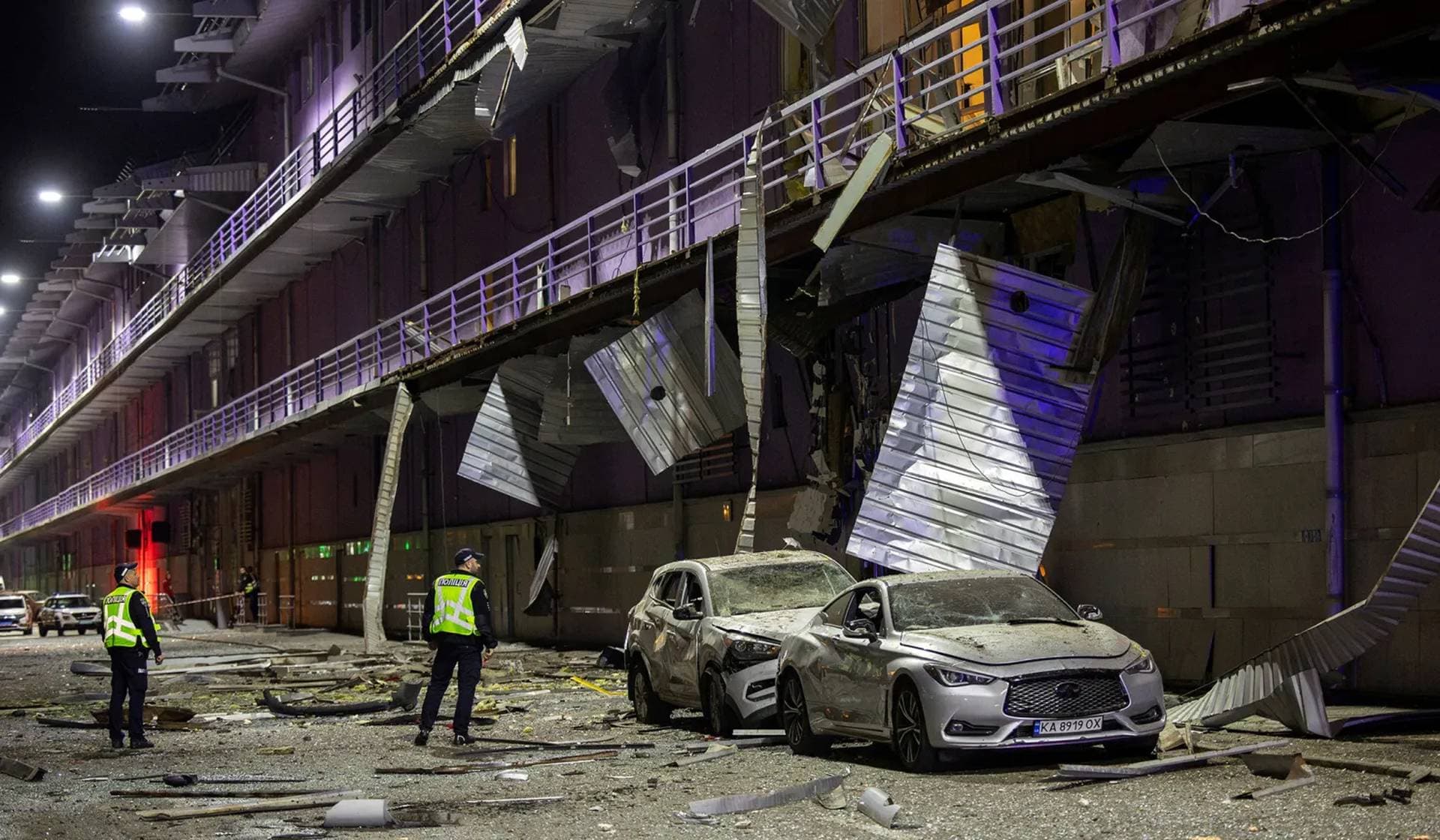 Policemen inspect a shopping mall that was damaged during a Russian drone attack in Kyiv