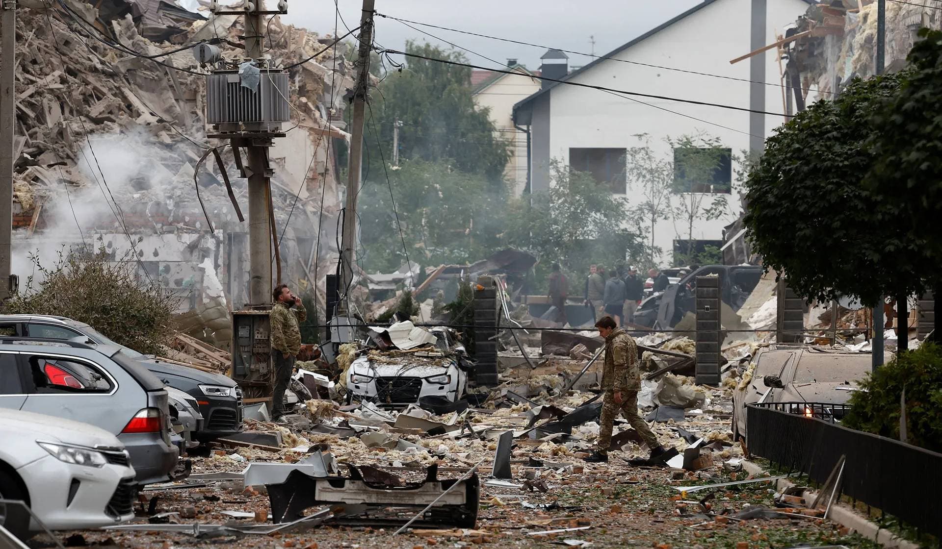 Emergency workers operate at an impact site in a residential neighbourhood after Russian drone and missile attacks in Kyiv