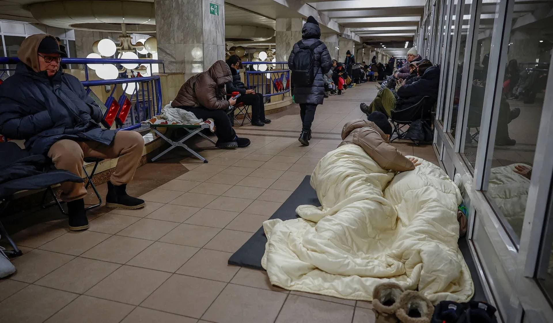 People take shelter inside a metro station during a Russian missile and drone strike in Kyiv