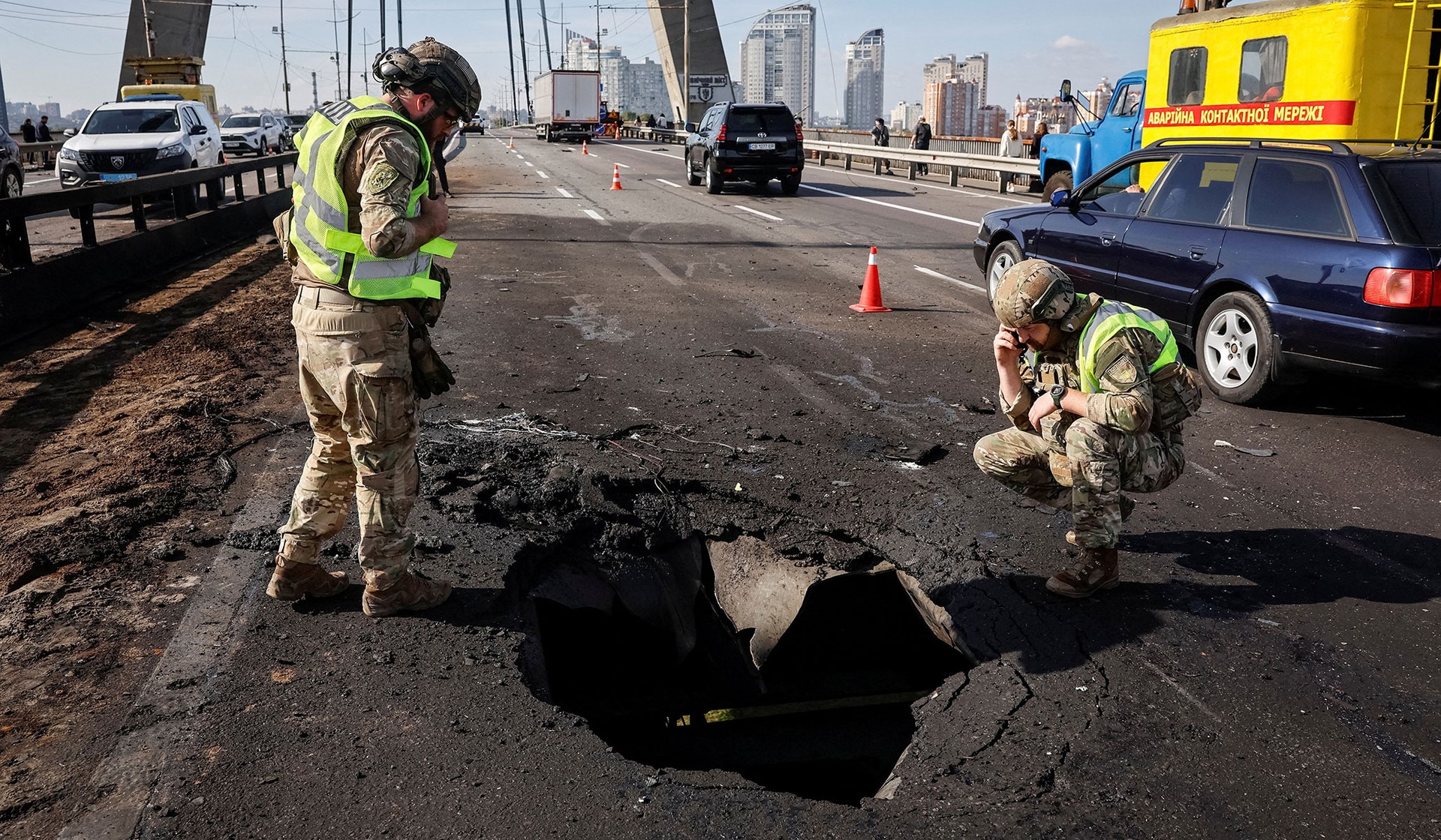 Police officers work at a site of the North Bridge hit by a Russian drone strike in Kyiv