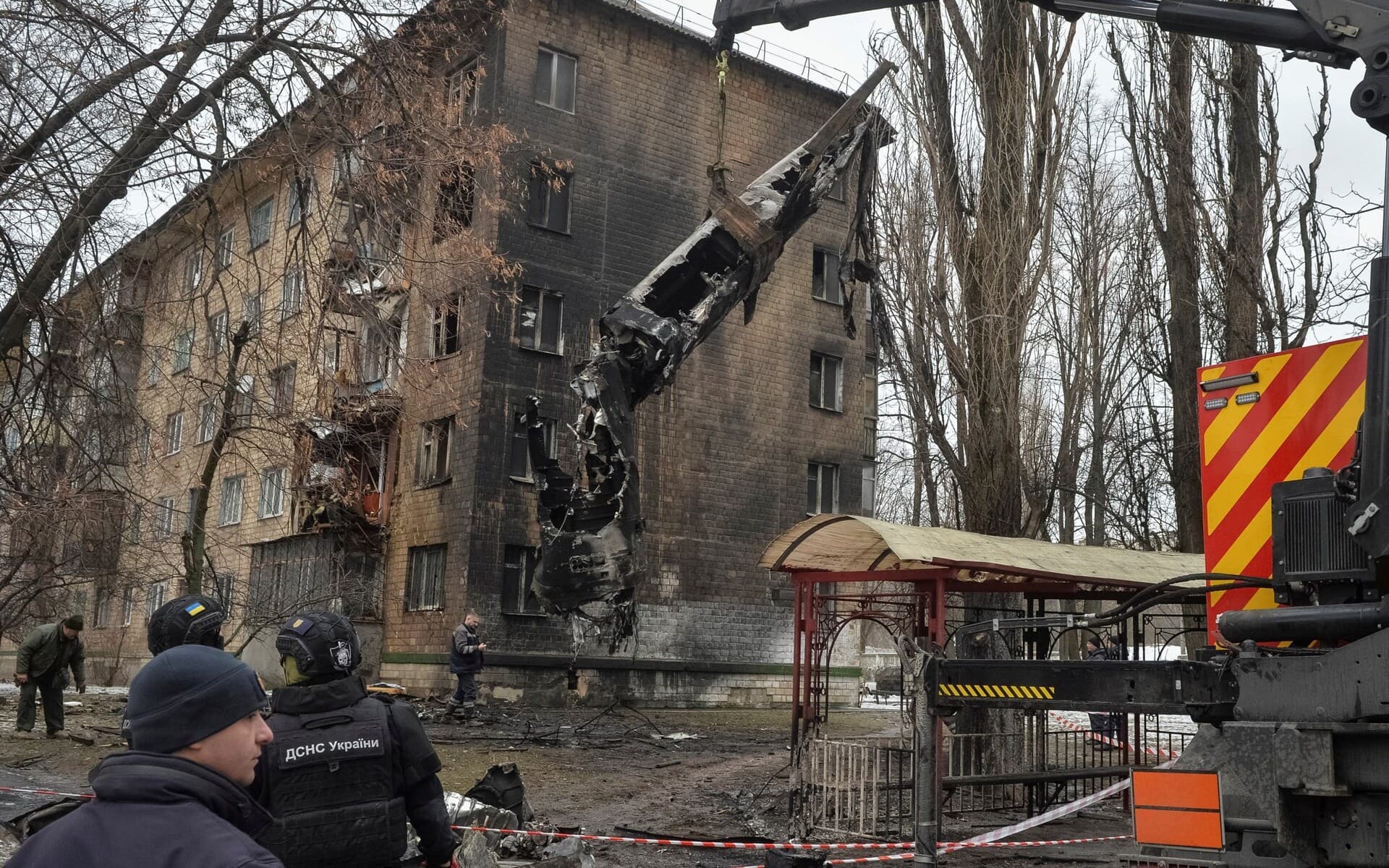 Bomb squad members load a part of a missile on a truck after a Russian missile attack in Kyiv