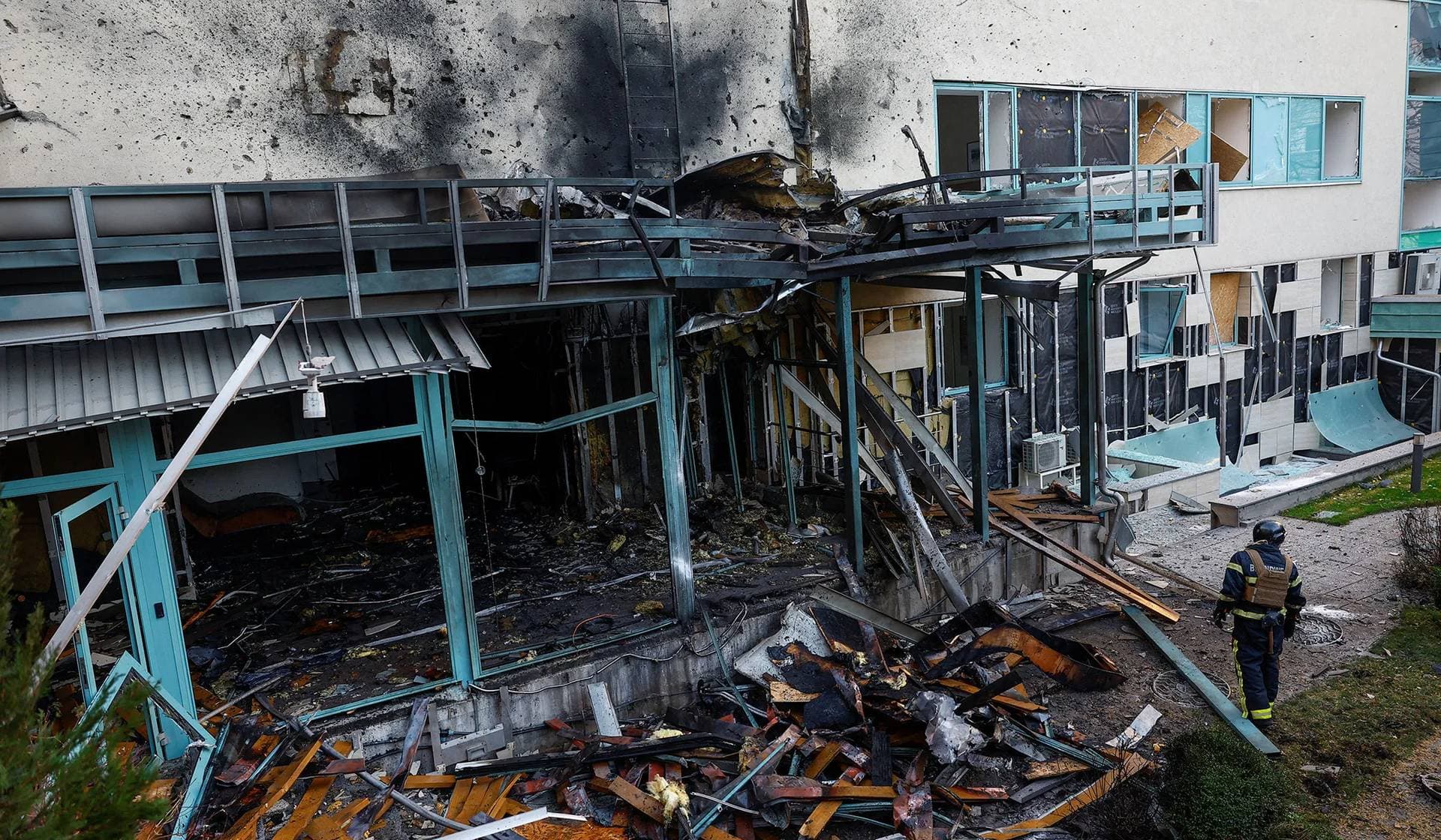 A firefighter works at a site of a medical centre damaged during a Russian drone strike in Kyiv