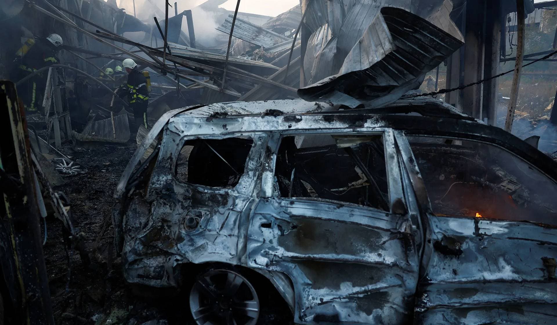 Firefighters work at a site in a residential area damaged during a Russian missile strike in Kyiv