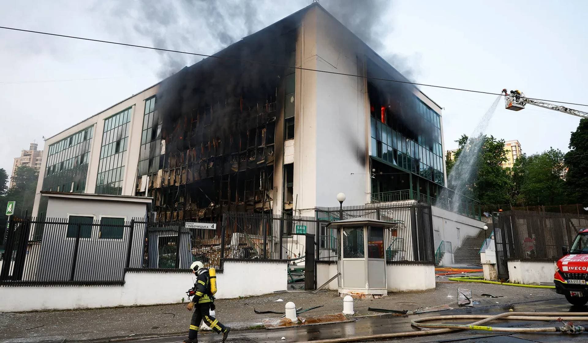 A firefighter works at the site of a Russian drone strike in Kyiv