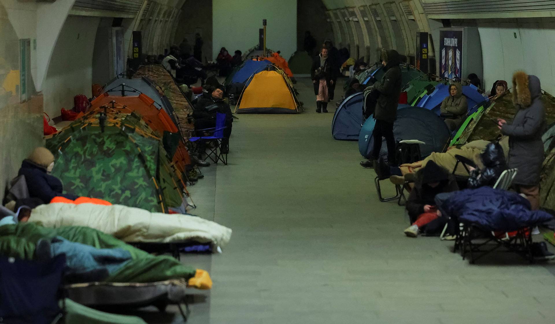 People take shelter inside a metro station during a Russian missile and drone strike in Kyiv