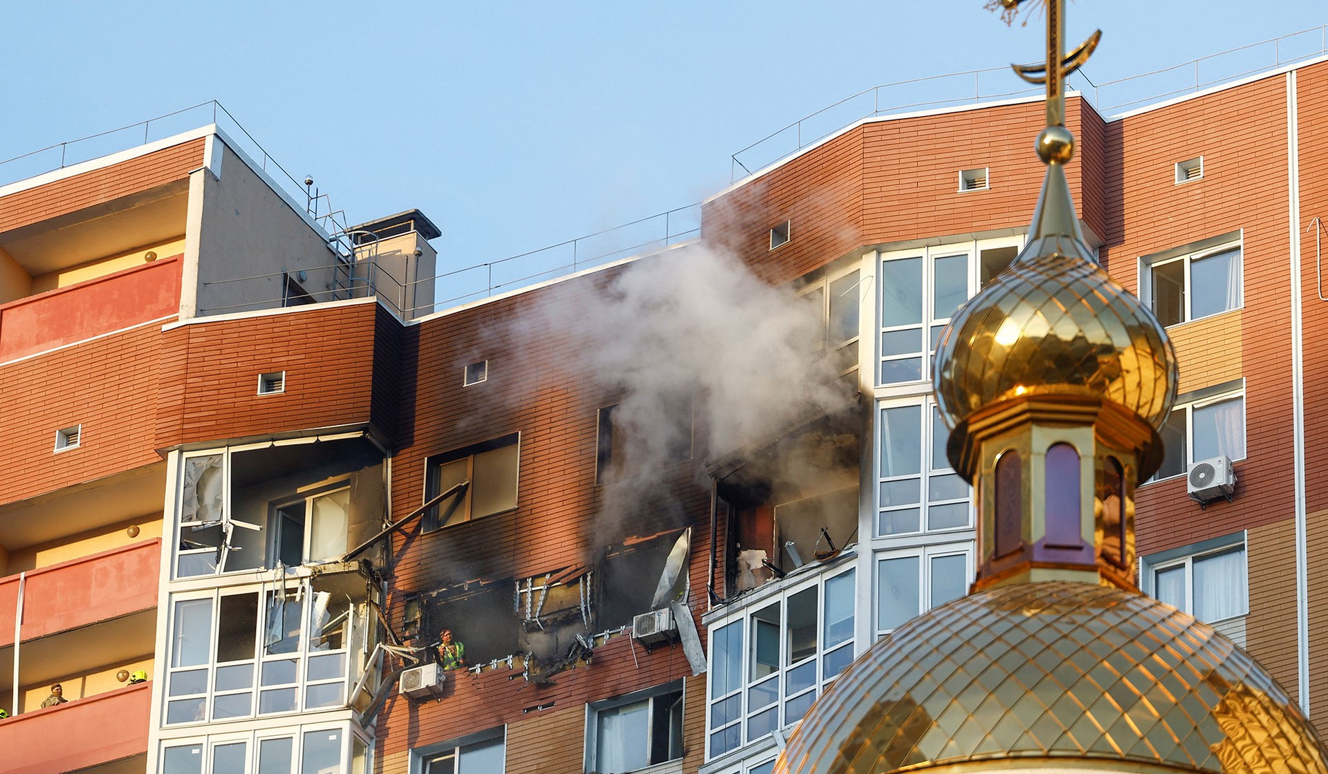 Smoke rises from an apartment building hit by a Russian drone strike in Kyiv