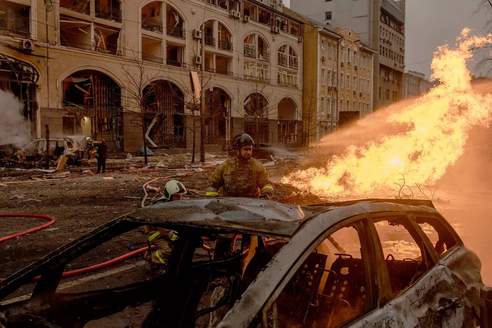 Ukrainian rescuers work to extinguish a fire at the site of a missile attack in Kyiv