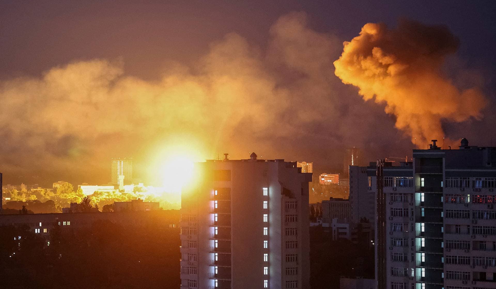 An explosion lights up the sky over the city during a Russian missile and drone strike in Kyiv