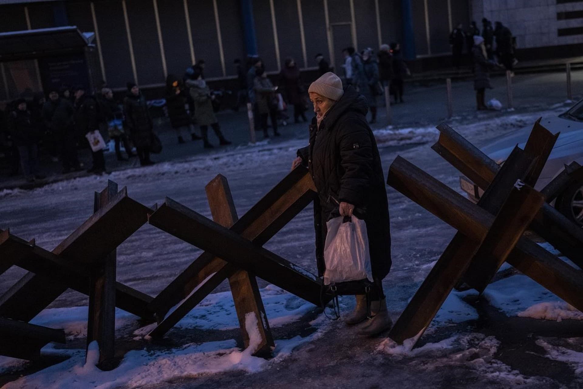 A woman walks between anti-tank hedgehogs in Kyiv