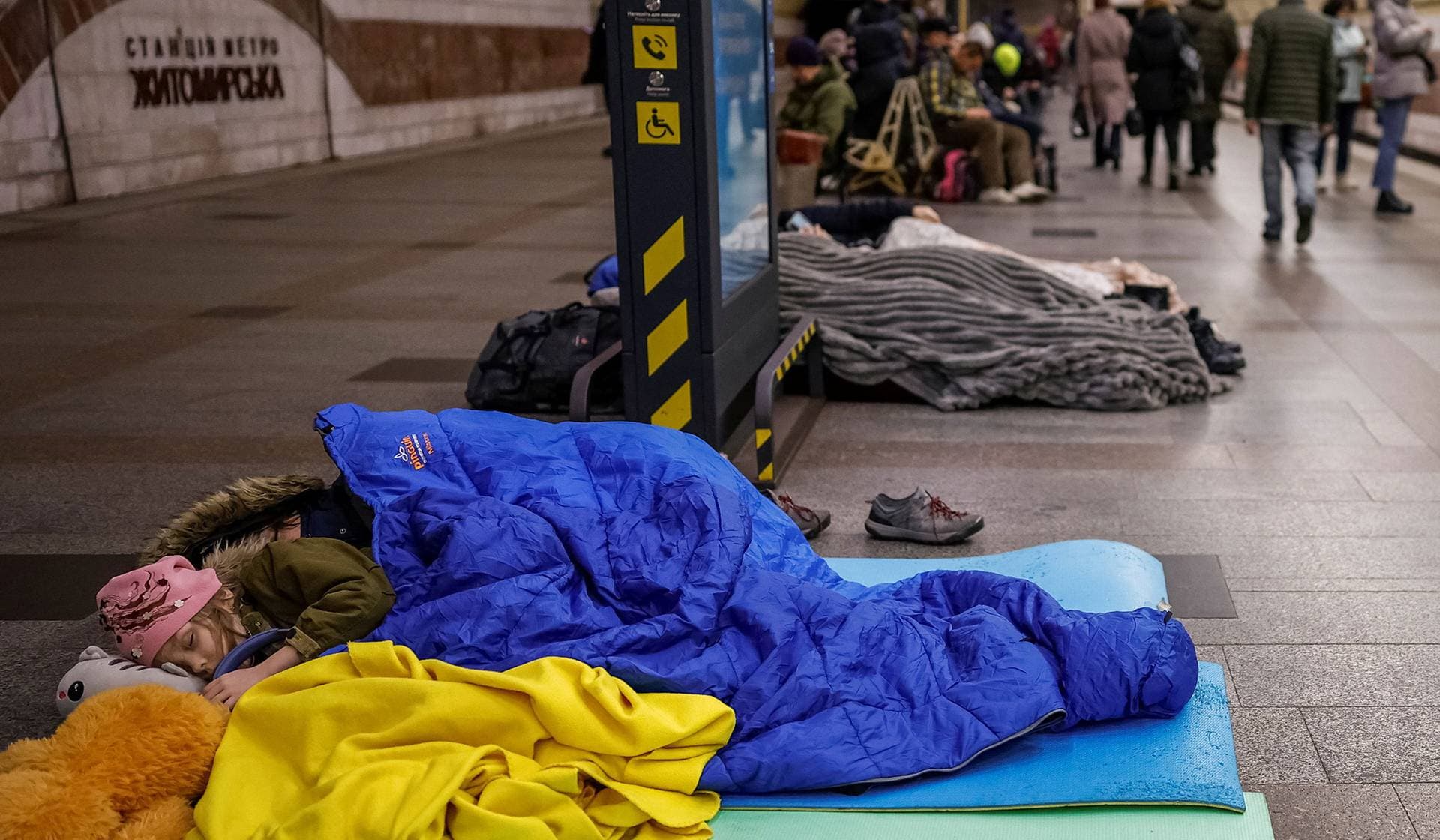 People take shelter inside a metro station during a Russian missile and drone strike in Kyiv