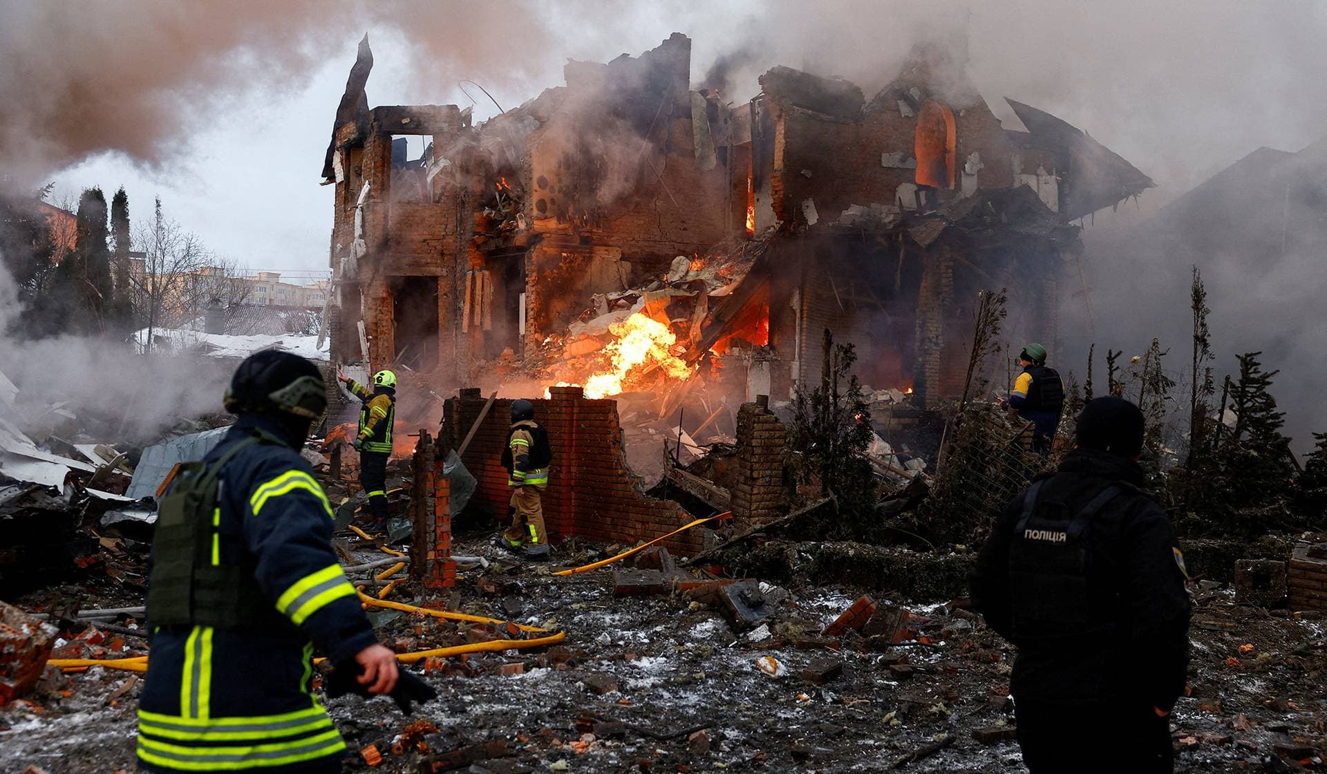 Firefighters work at the site of a residential building damaged during Russian drone and missile strikes in Kyiv