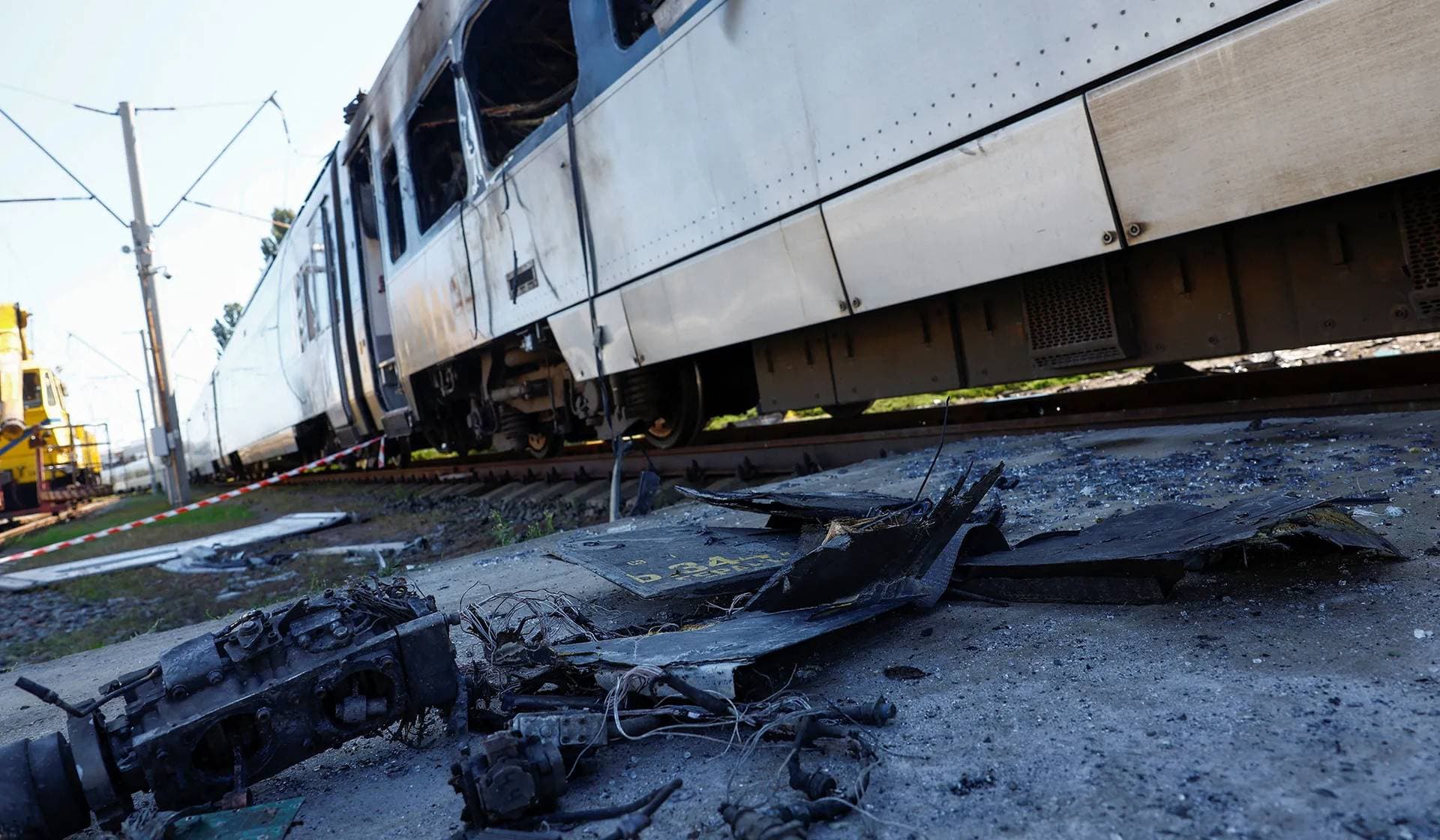 Remains of a Russian kamikaze drone lie next to a Ukrainian Railways HRCS2 Hyundai Rotem train hit by a strike in Kyiv
