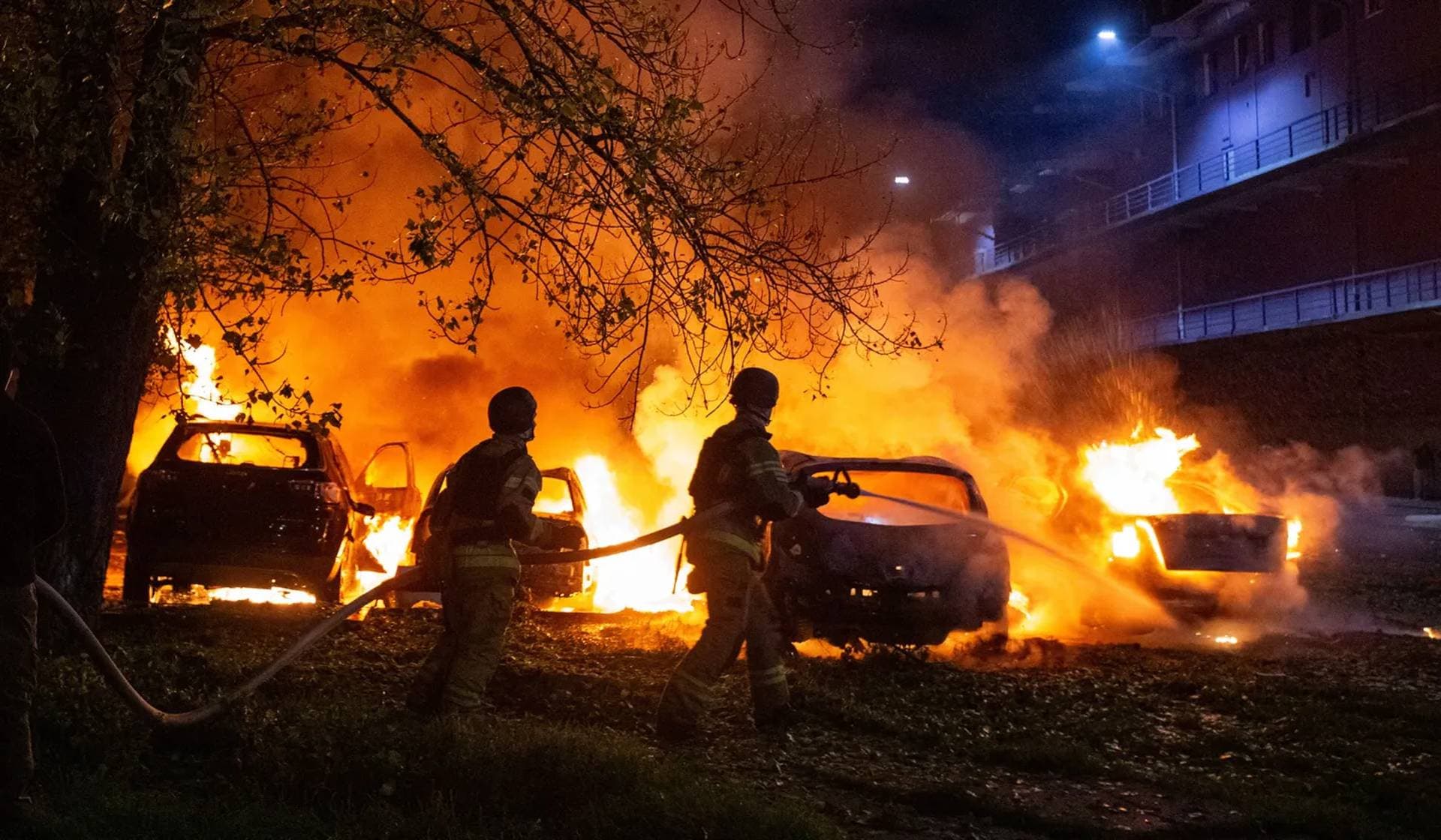 Firefighters work at the site of a Russian drone strike in Kyiv