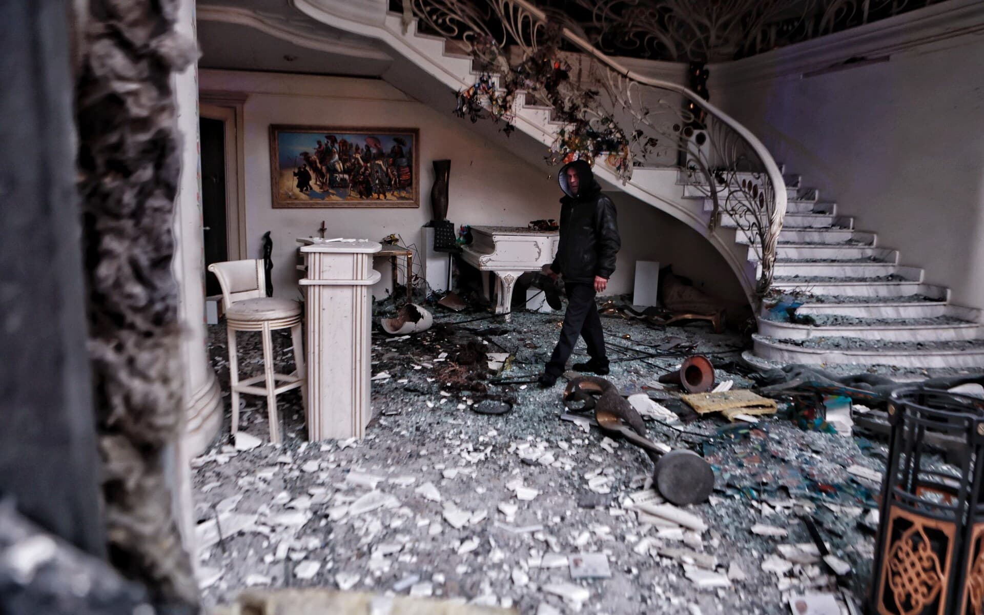 Someone surveys the damage in a restaurant in Kyiv