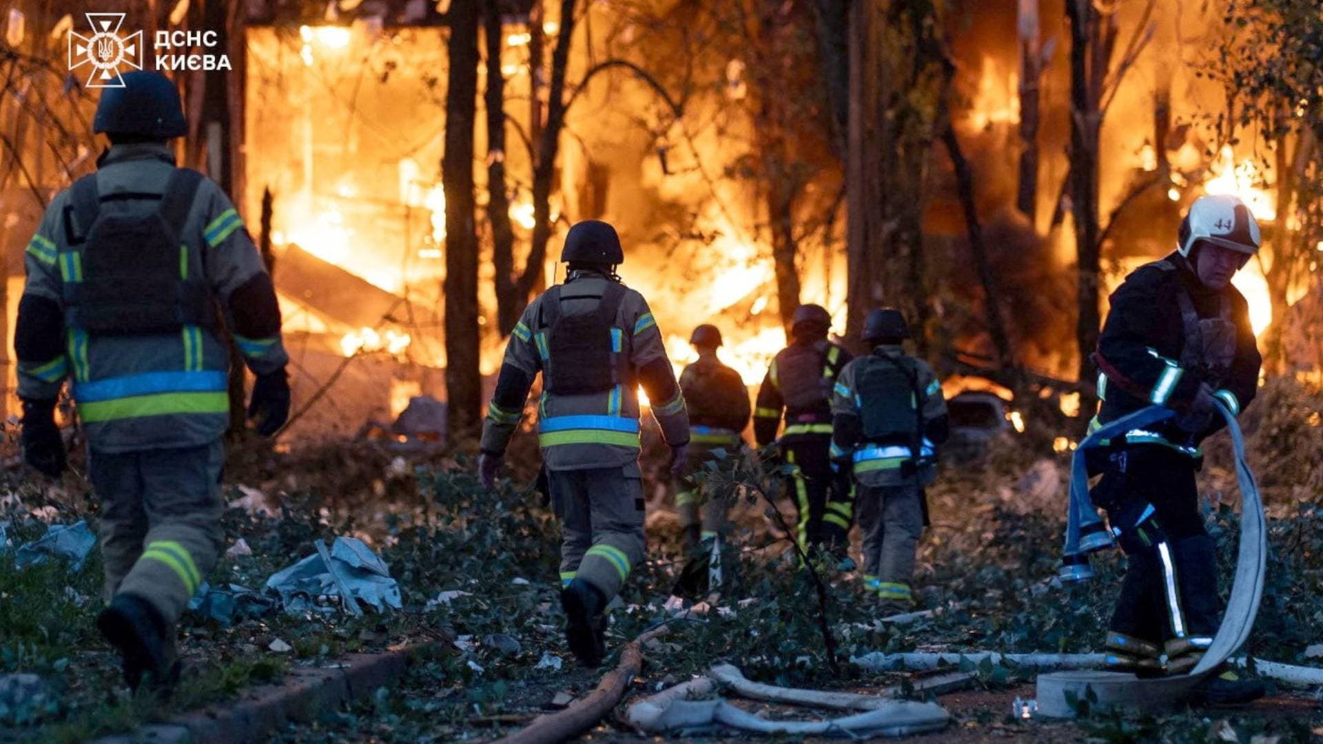 Firefighters work at the site of the Russian drone and missile strike in Kyiv