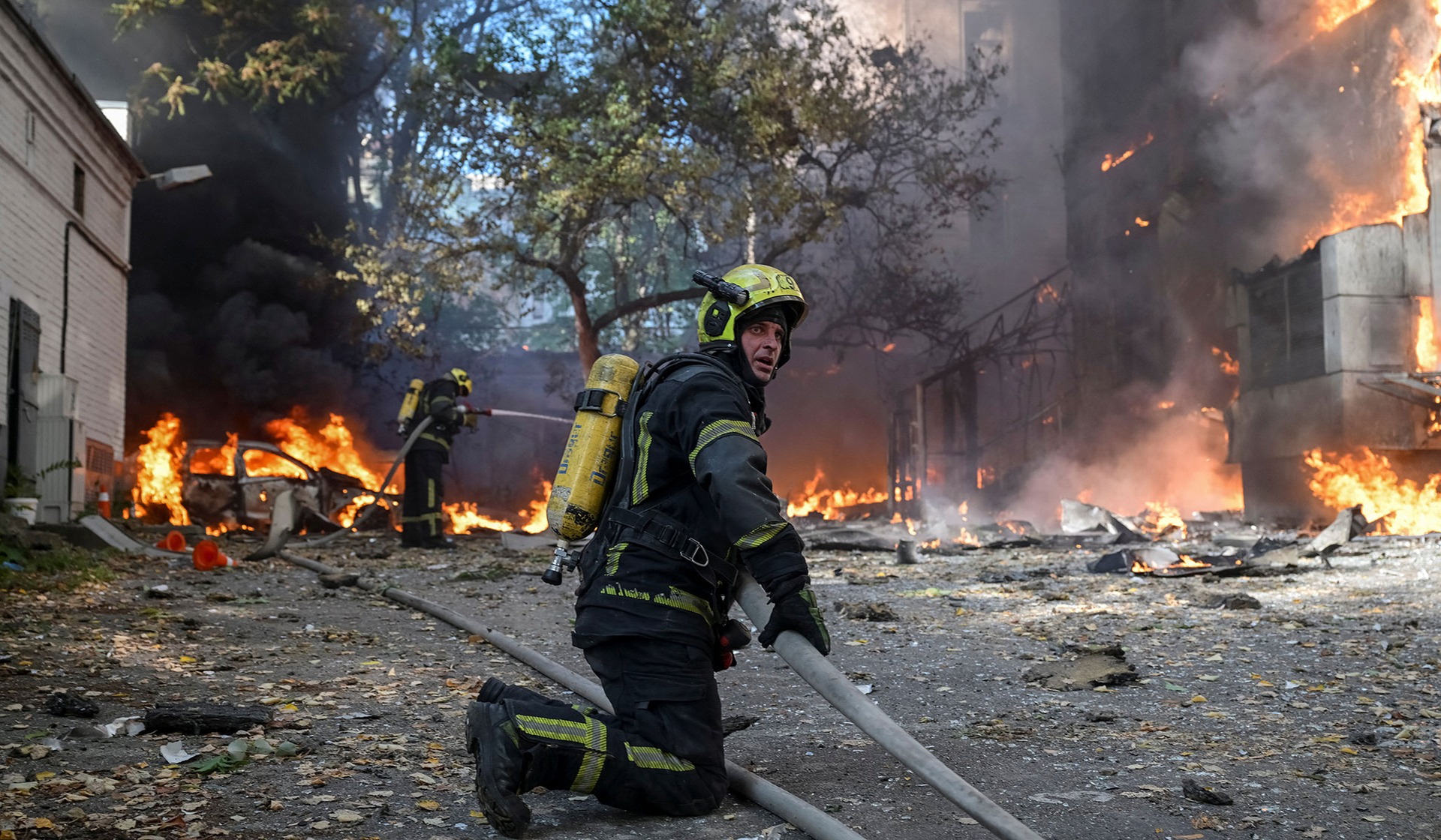 Firefighters work at the site of a building of a private medical centre hit by a Russian drone strike in Kyiv