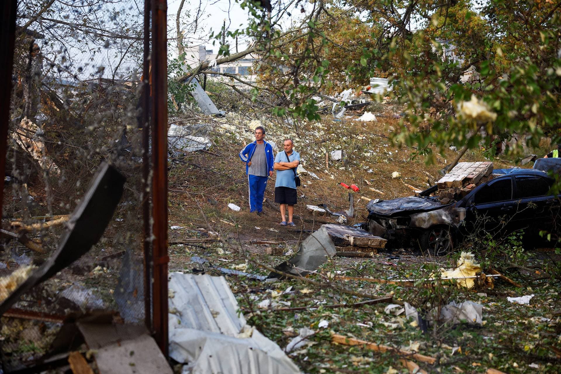 Residents in Kyiv survey the damage following the early morning missile attack