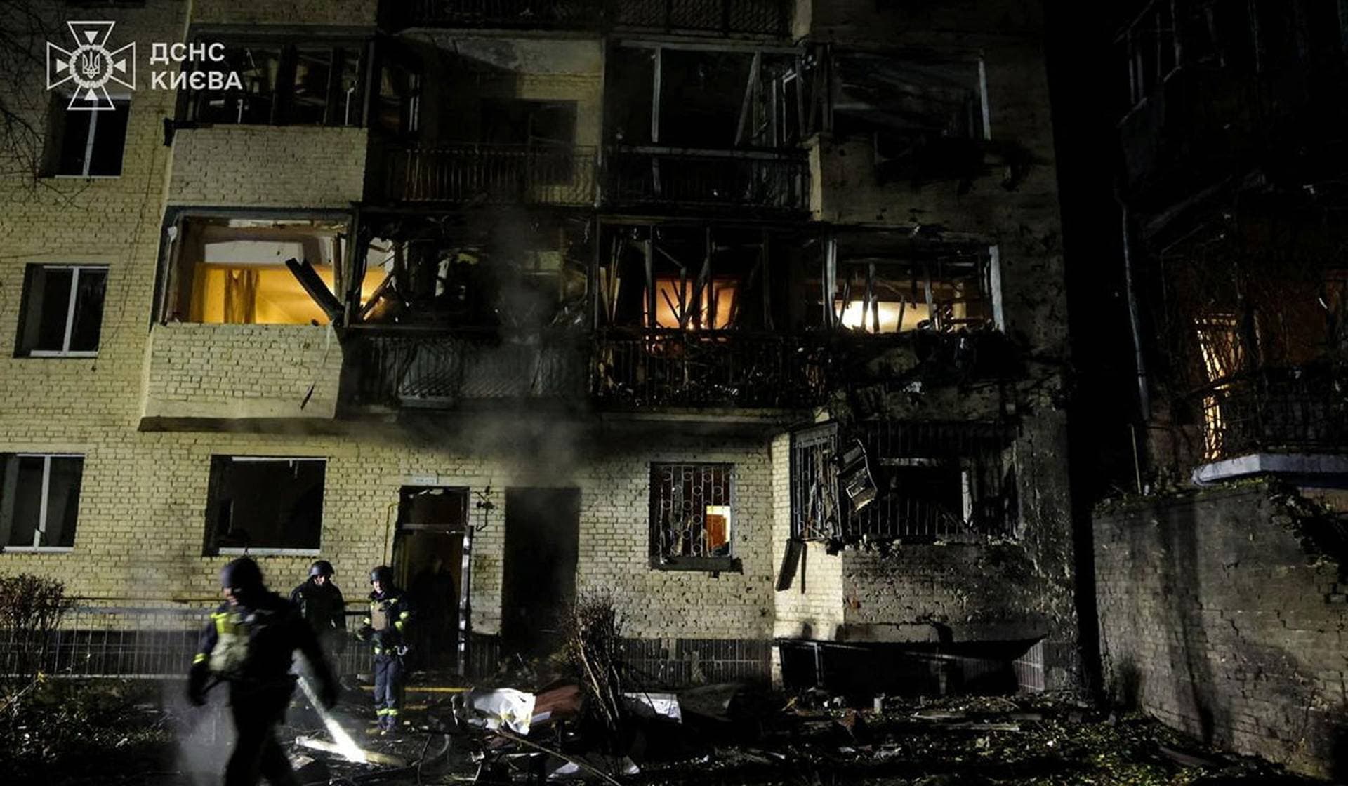 Rescuers work at the site of the apartment building damaged by a Russian drone strike in Kyiv