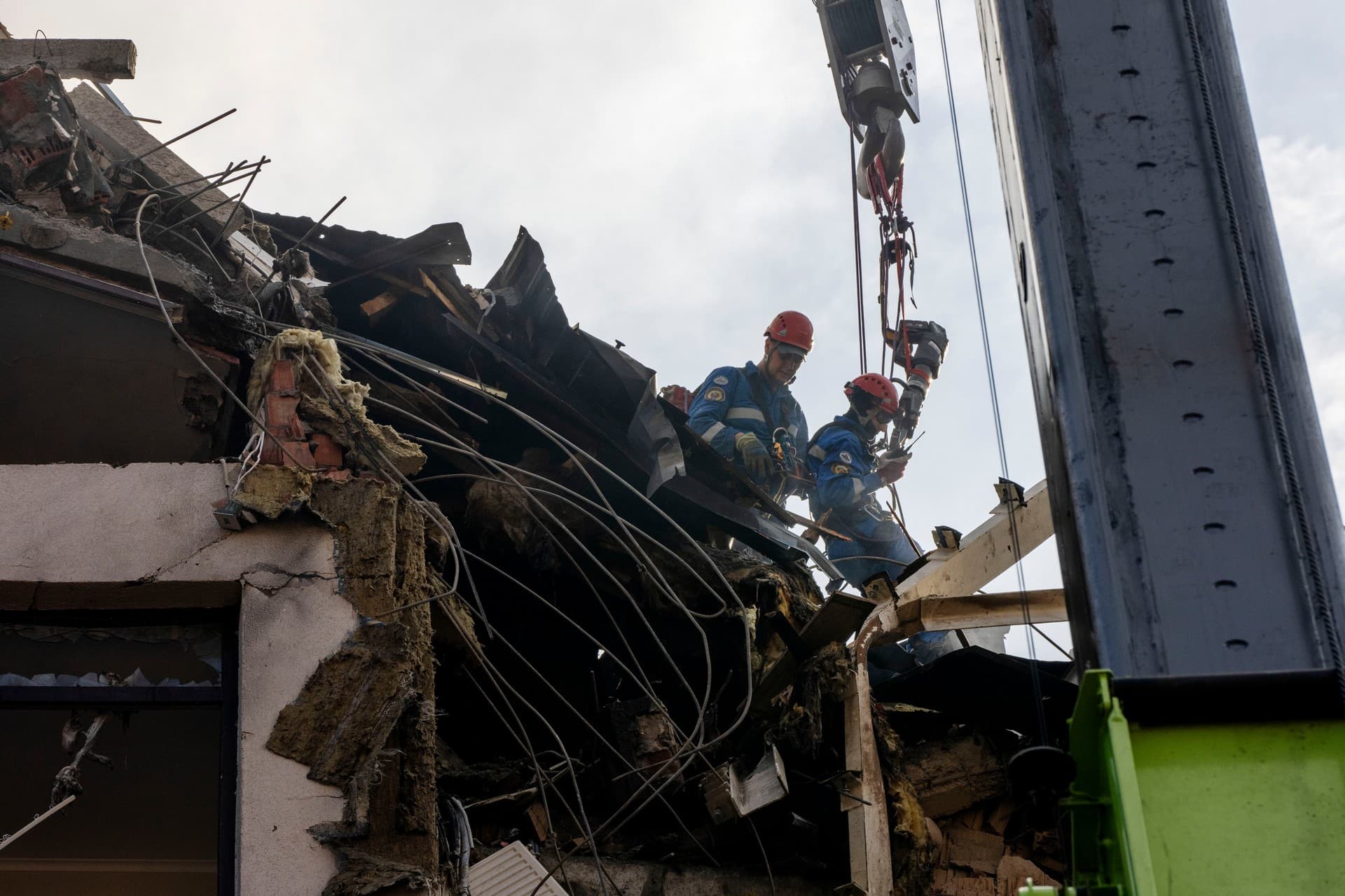 Firefighters work at the scene of a residential building following explosions, in Kyiv