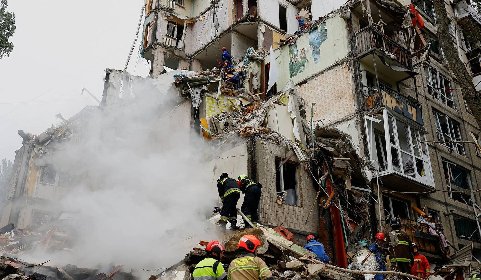 Rescuers work at the site of an apartment building hit during Russian missile and drone strikes in Kyiv