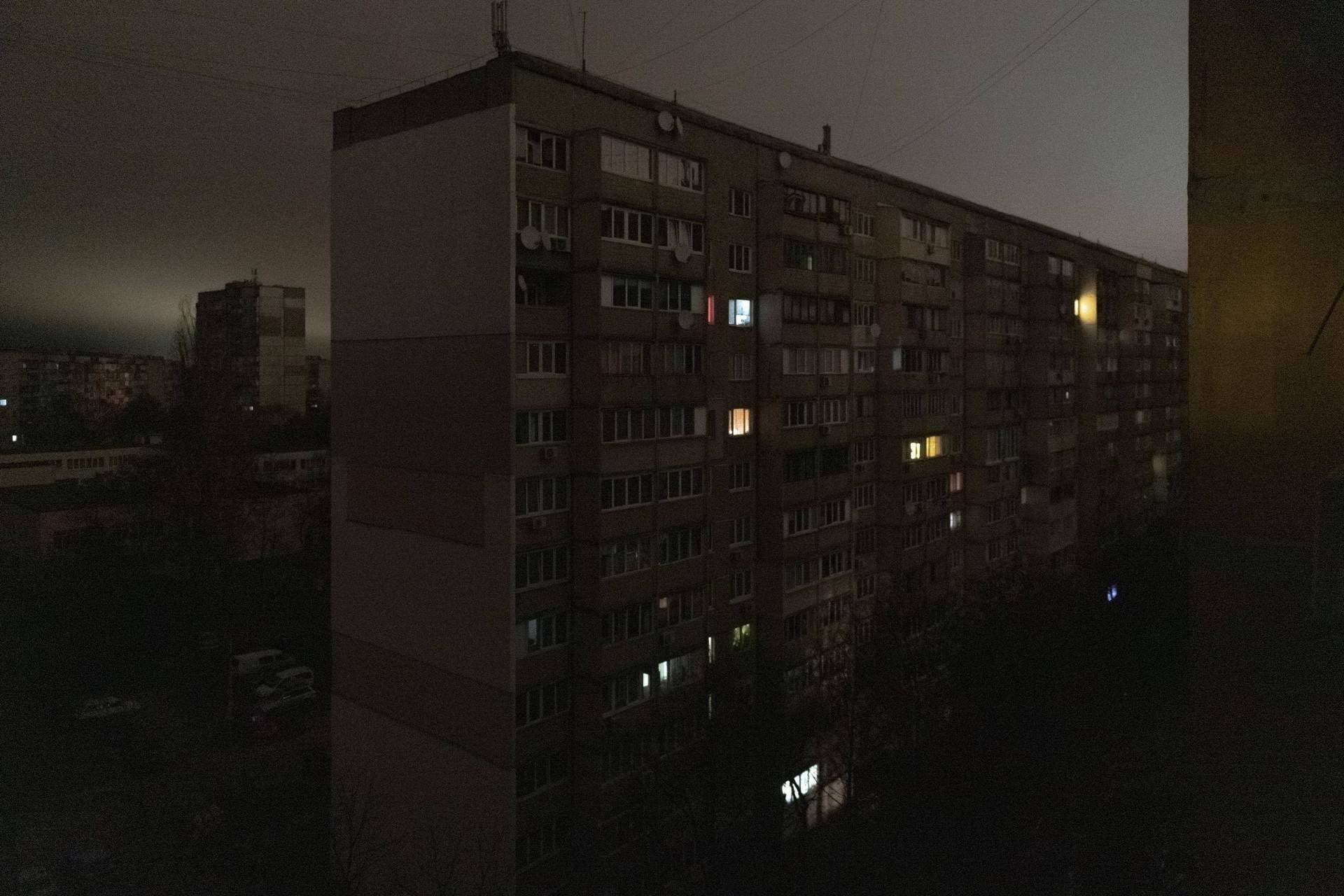 Windows of an apartment building are illuminated during a blackout in Kyiv