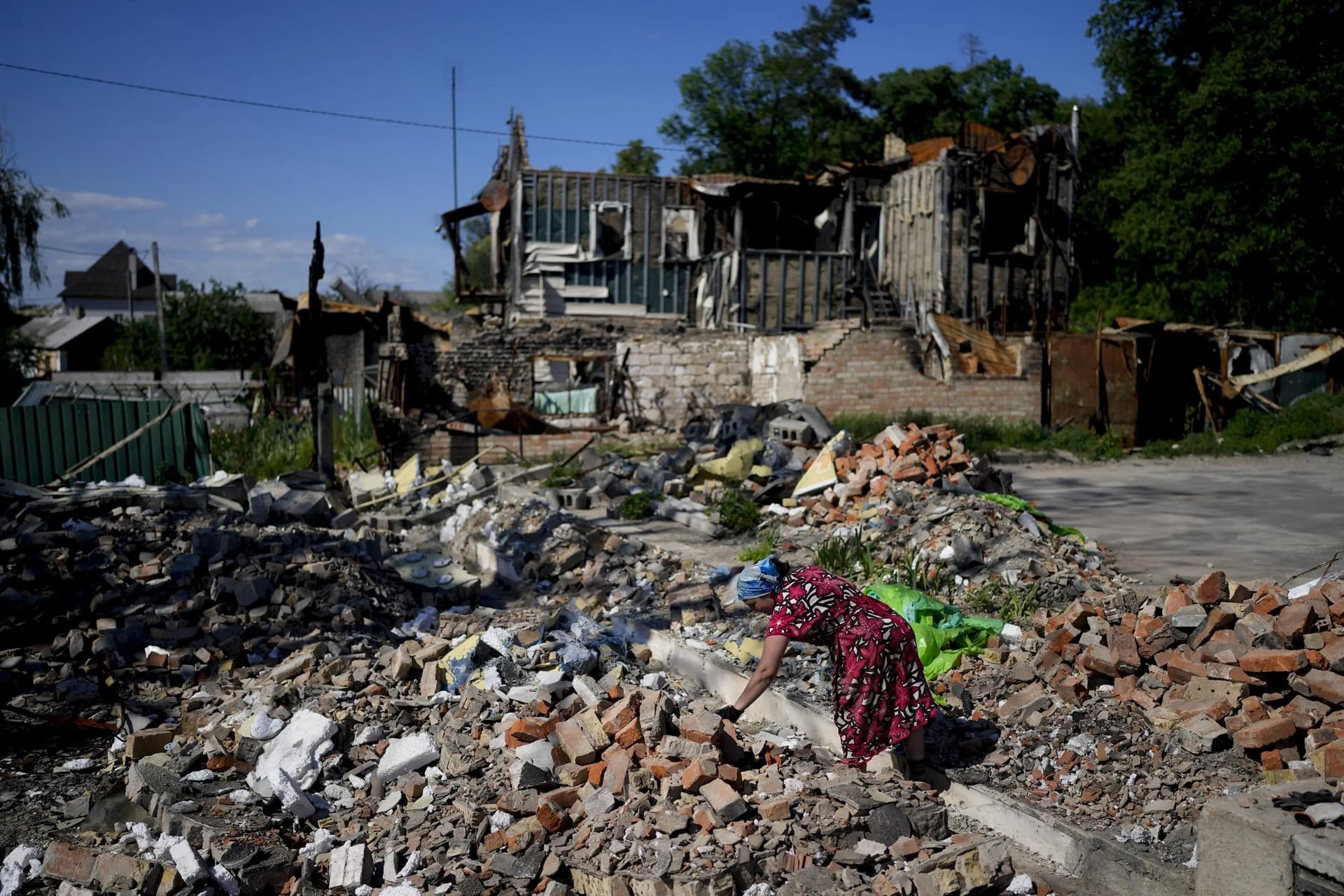 Melania works clearing the rubble of a temple that was destroyed during attacks in Gorenka