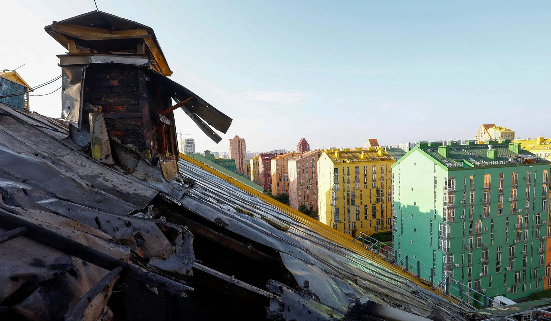 A police officer inspects the remains of a Russian cruise missile shot down by Air Defence Forces in Kyiv