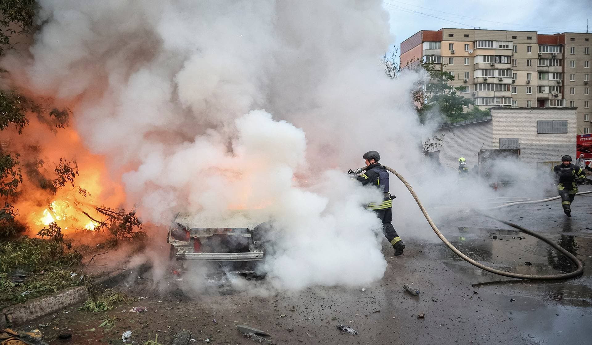 Firefighters work at a site of a Russian missile and drone strikes in Kyiv