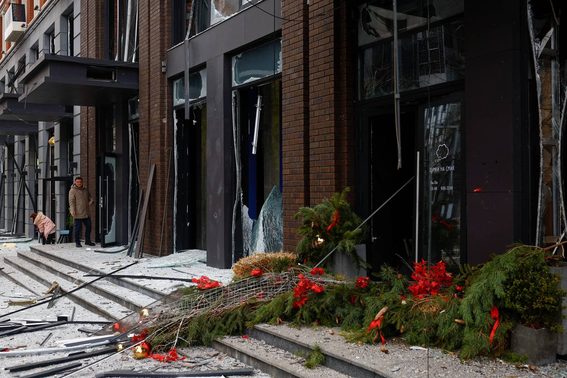 A person looks at a damaged Christmas tree after a Russian missile strike in central Kyiv