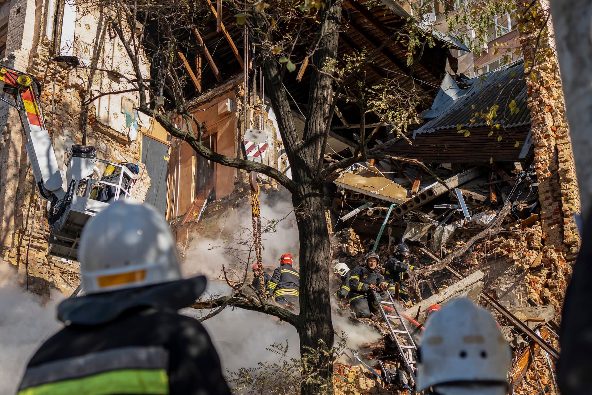Firefighters work after a drone fired on buildings in Kyiv