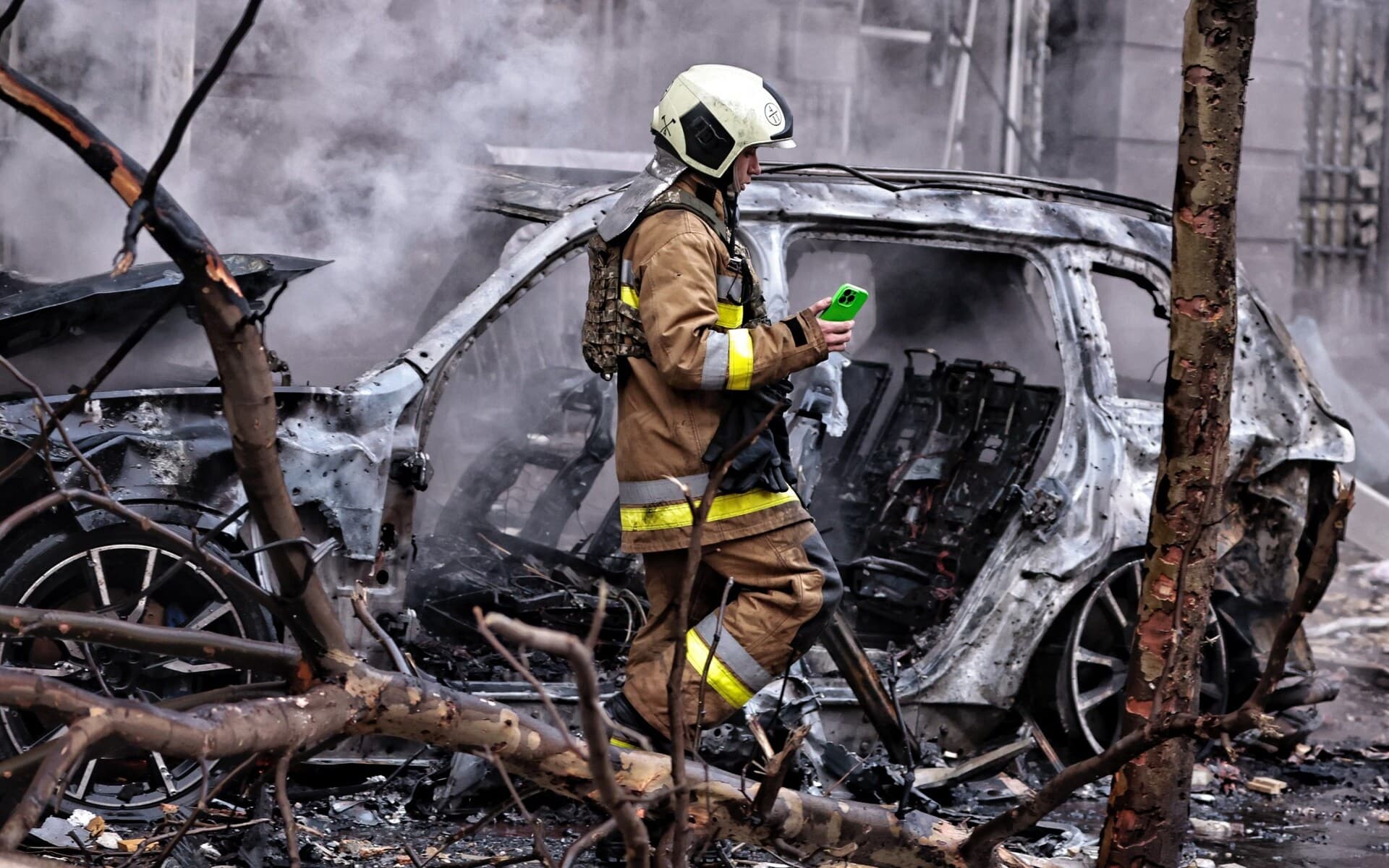 A rescue worker searches through the wreckage in Kyiv