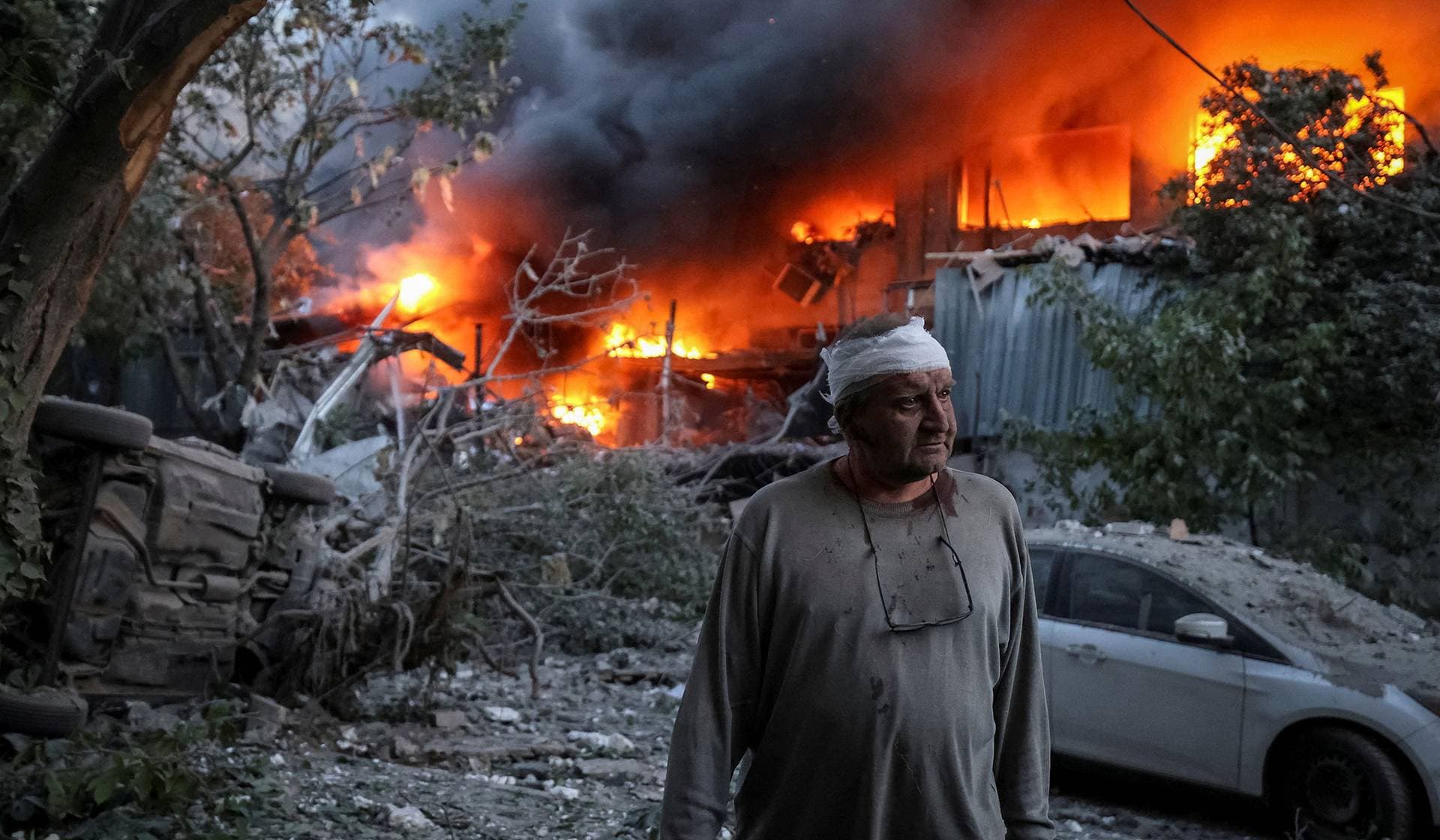 A resident stands at a site of a Russian drone and missile strike in Kyiv