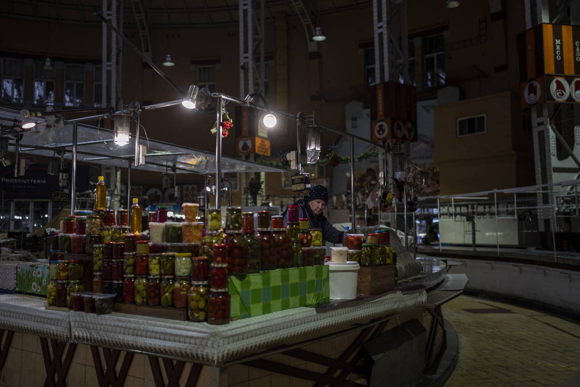 A vendor waits for customers inside a market in Kyiv