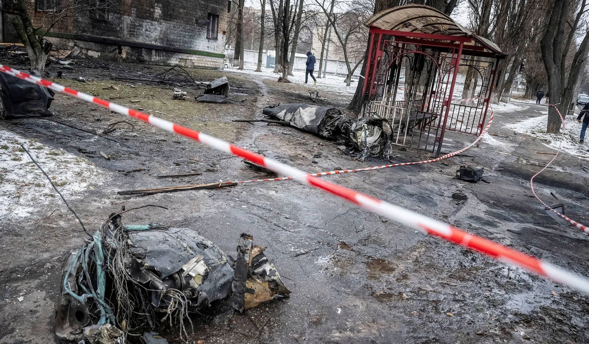 Parts of a missile lie on the ground near an apartment building damaged during a Russian missile strike in Kyiv