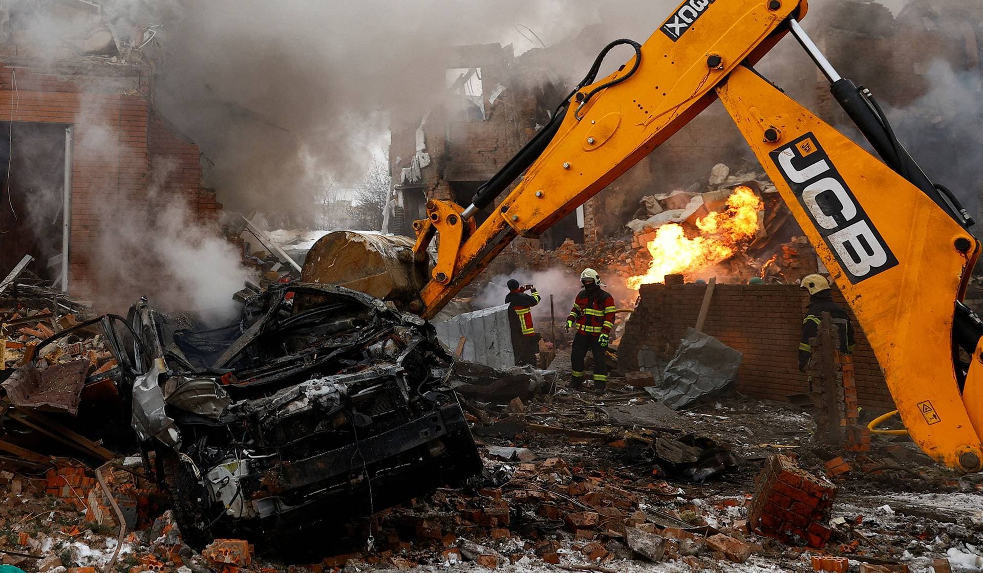 Firefighters work at the site of a residential building damaged during Russian drone and missile strikes in Kyiv