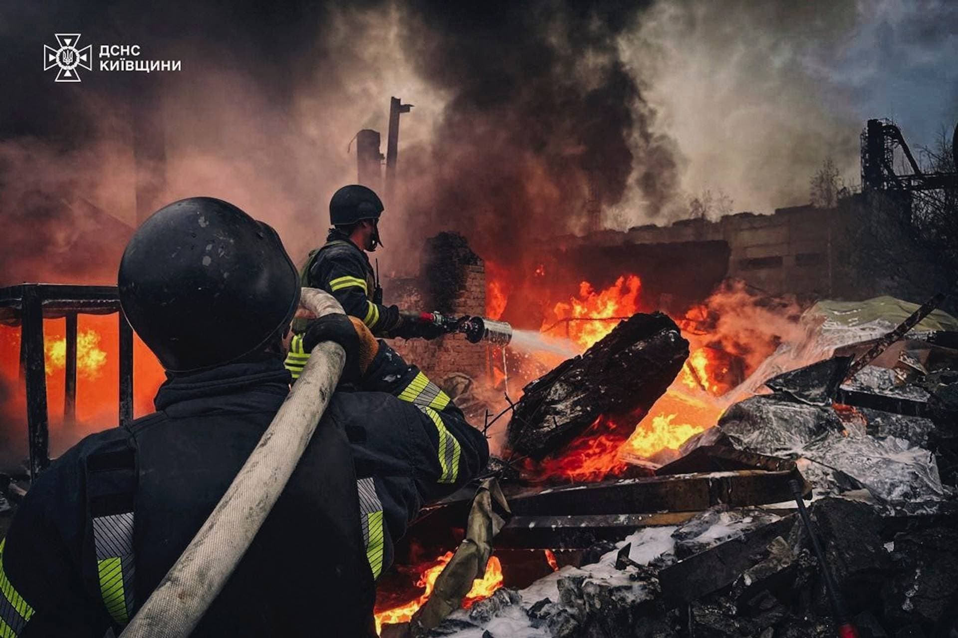 Firefighters work at the site where an industrial area was hit by a Russian missile strike in Kyiv Region