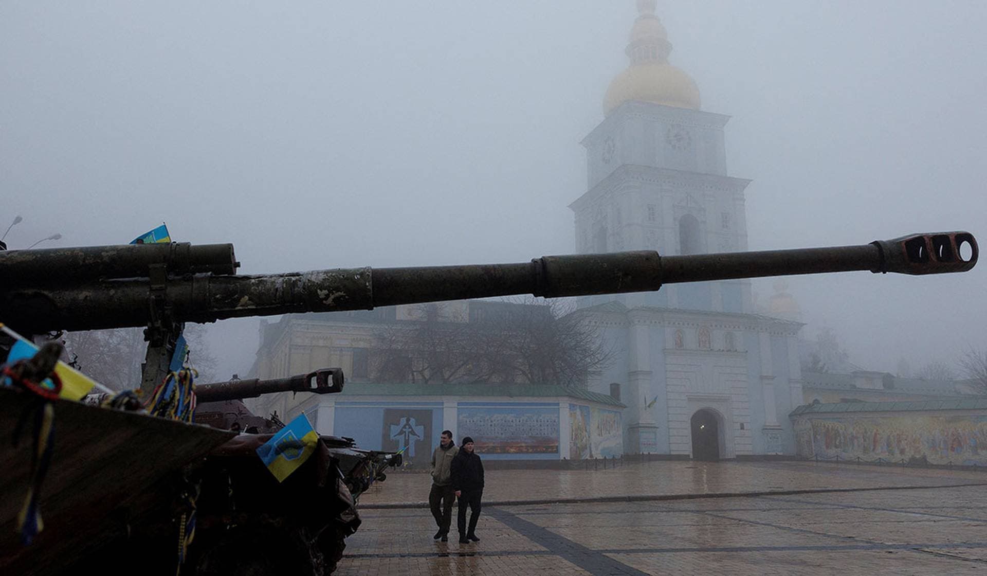 Men visit an exhibition displaying destroyed Russian military vehicles and weapons in front of St. Michael's Cathedral in Kyiv