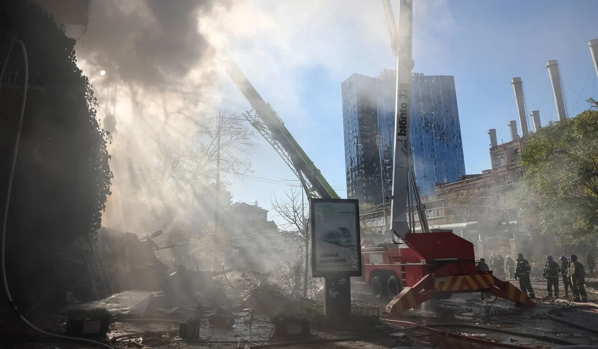Firefighters work to put out a fire in a residential building destroyed in a strike by Russian drones in Kyiv