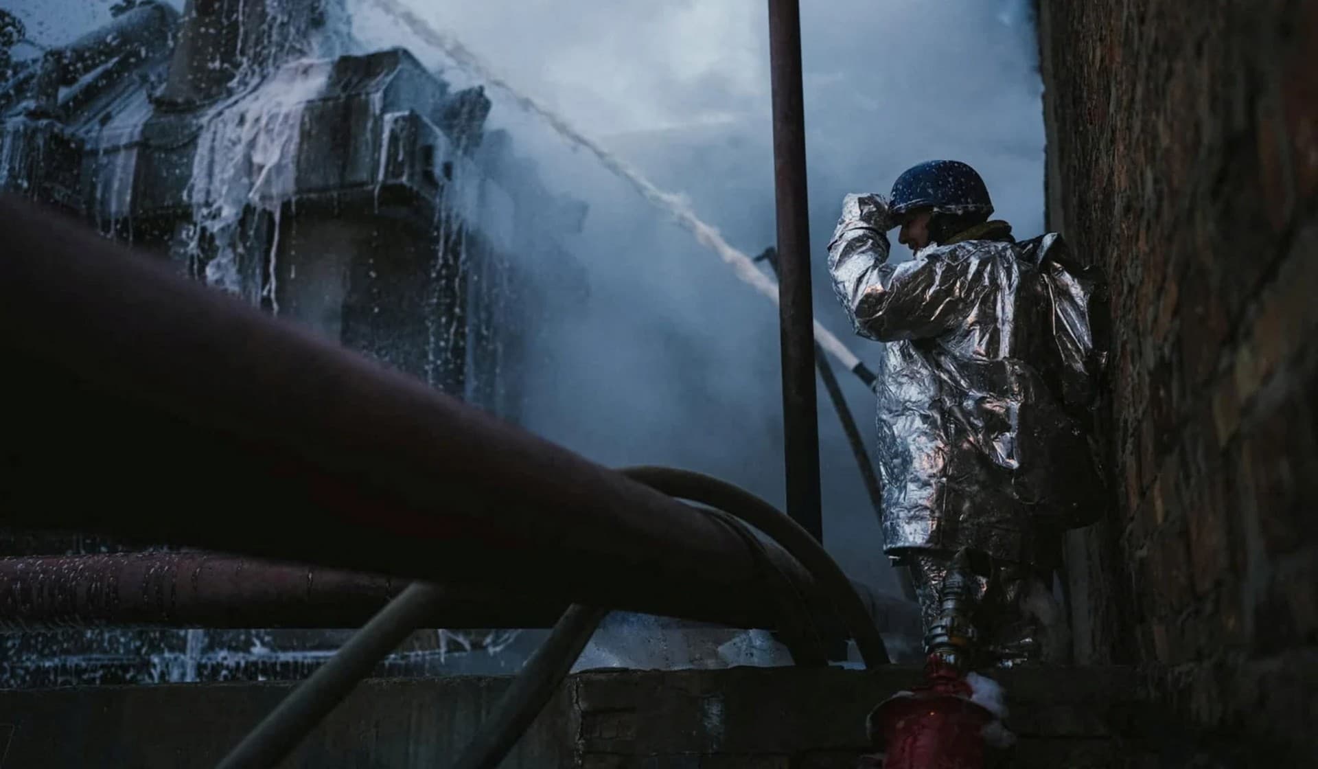 A firefighter works at a site of critical power infrastructure hit during Russia's drones attacks in Kyiv